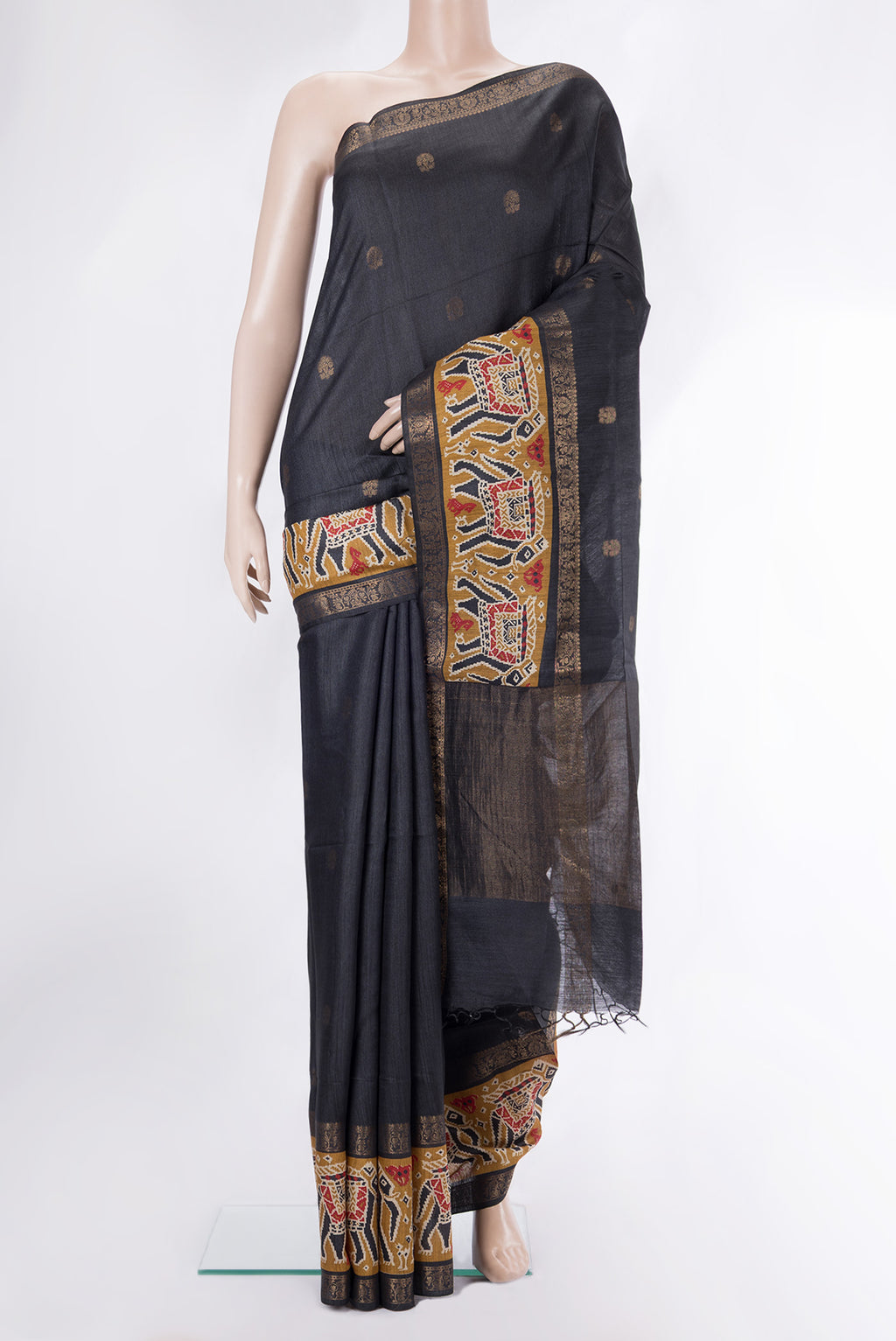 Black Tussar Saree with Zari Butta on the body and Fancy Border.  displayed on a mannequin