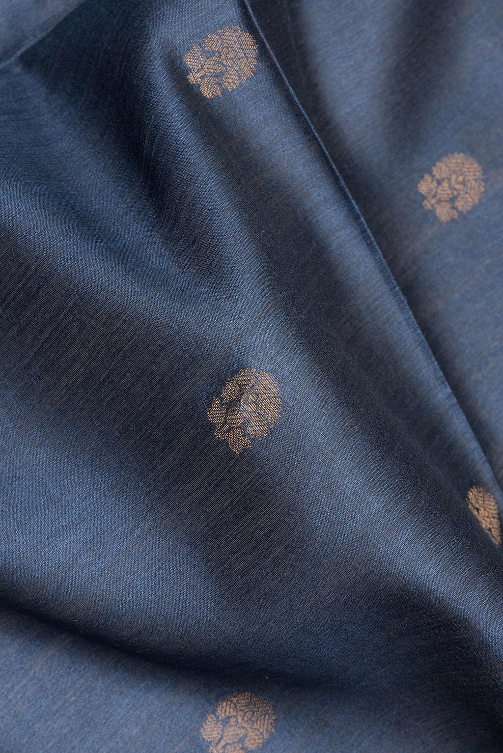 Close up of Grey Dual Tone Tussar Saree with Zari Butta on the body and Fancy Border.  displaying folds