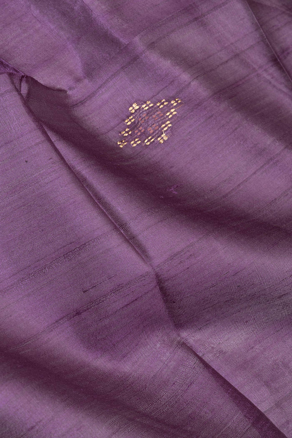 Close up of Violet Tussar Silk Saree with Zari Butta on the body and Zari Border.  displaying folds