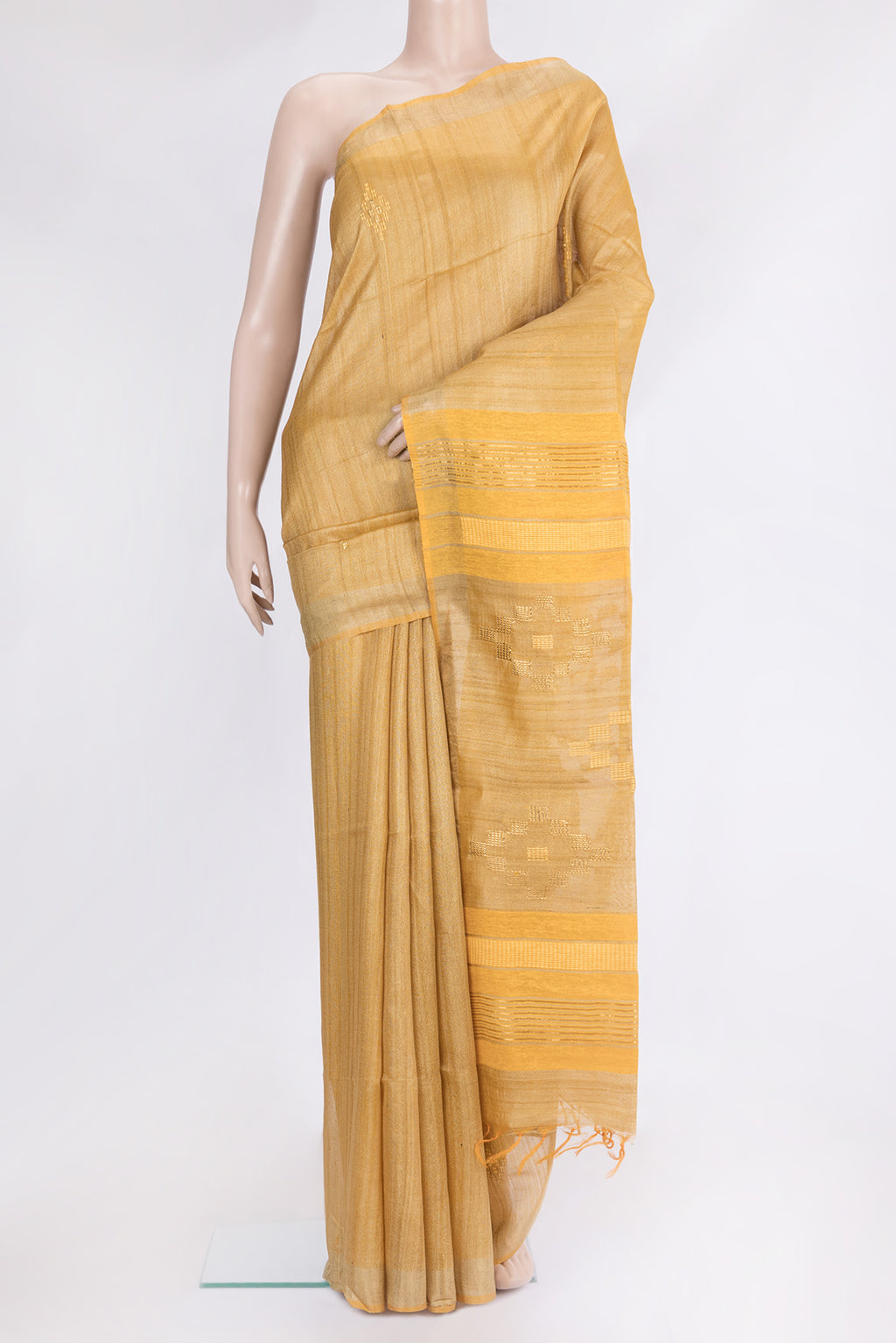 Mustard Tussar Silk Saree with Embroidery on the body and Zari Border.  displayed on a mannequin