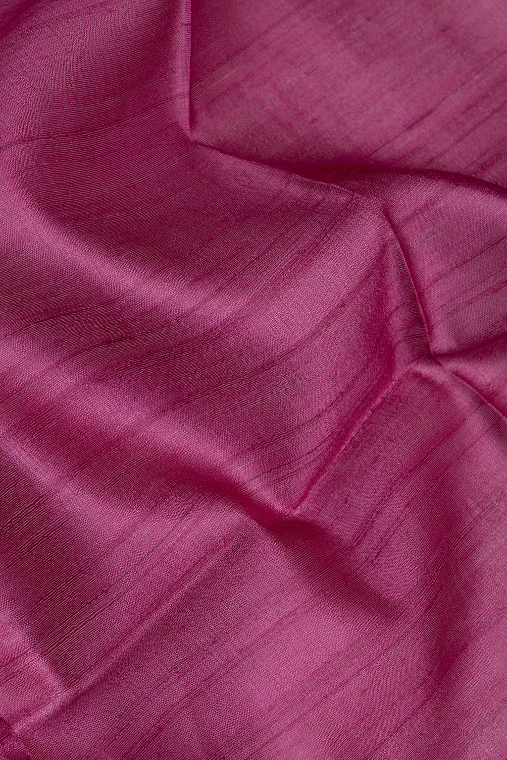 Close up of Pink Tussar Silk Saree with Thread Butta on the body and Zari Border.  displaying folds