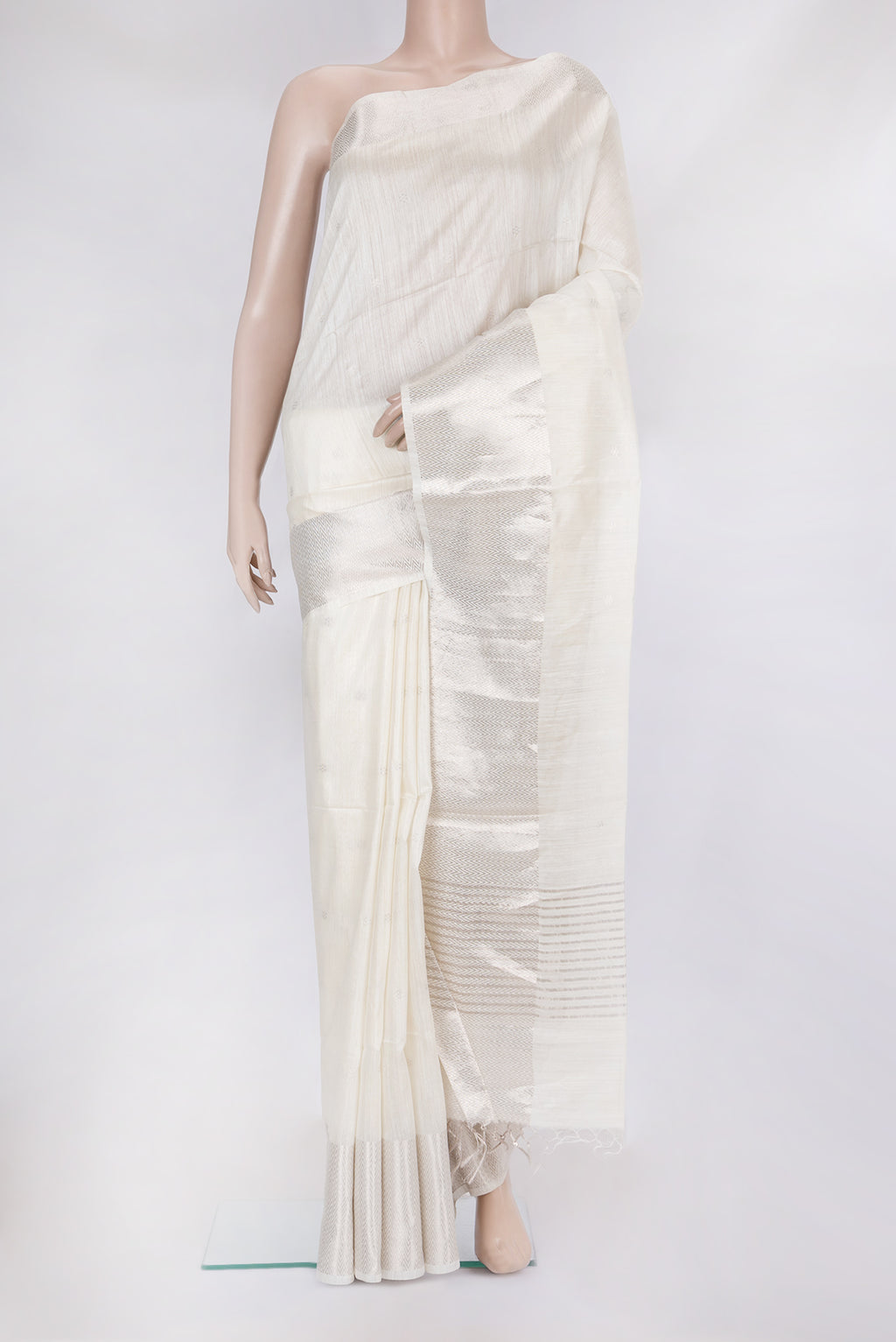 White Tussar Silk Saree with Zari Butta on the body and Zari Border.  displayed on a mannequin