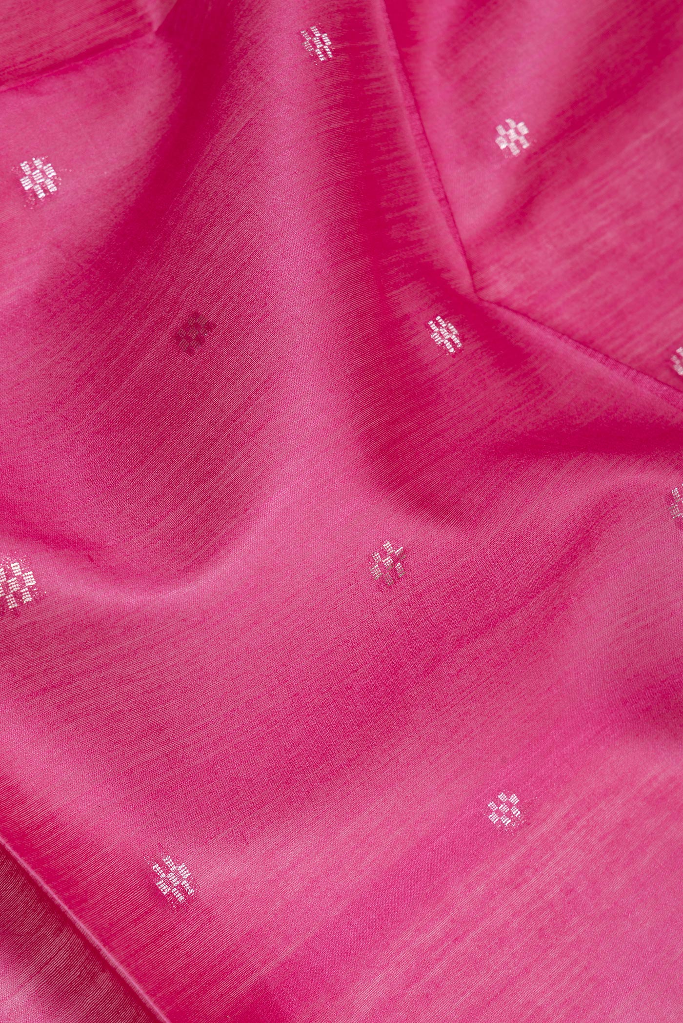 Close up of Pink Dual Tone Tussar Silk Saree with Zari Butta on the body and Zari Border.  displaying folds