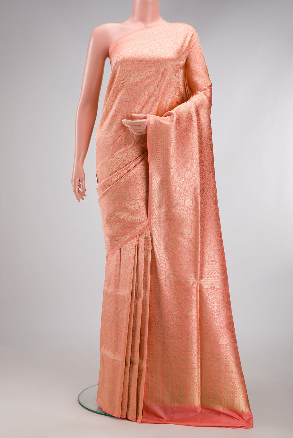 Peach Banarasi Silk Saree with Zari Brocade on the body and Zari Border.  displayed on a mannequin
