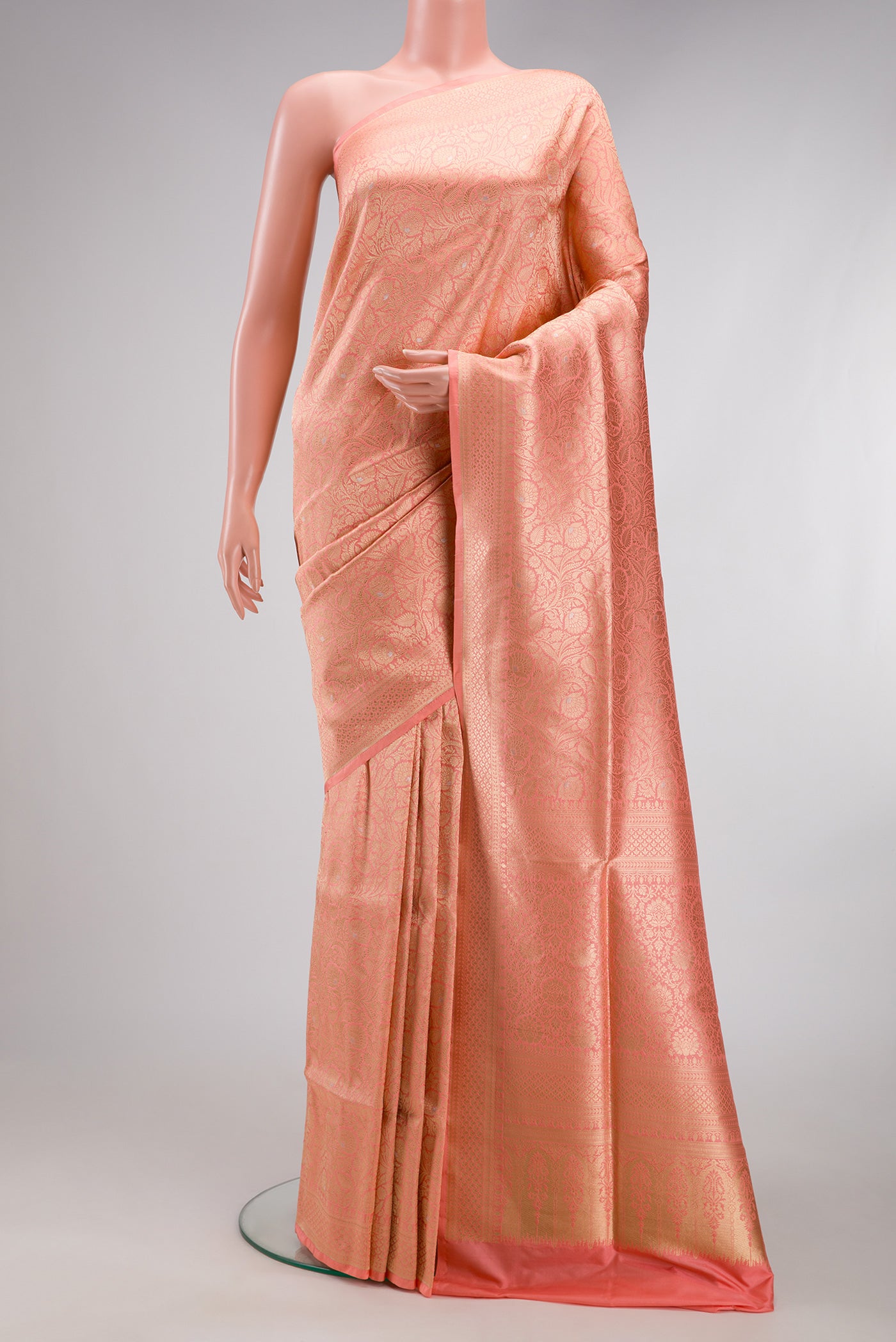 Peach Banarasi Silk Saree with Zari Brocade on the body and Zari Border.  displayed on a mannequin