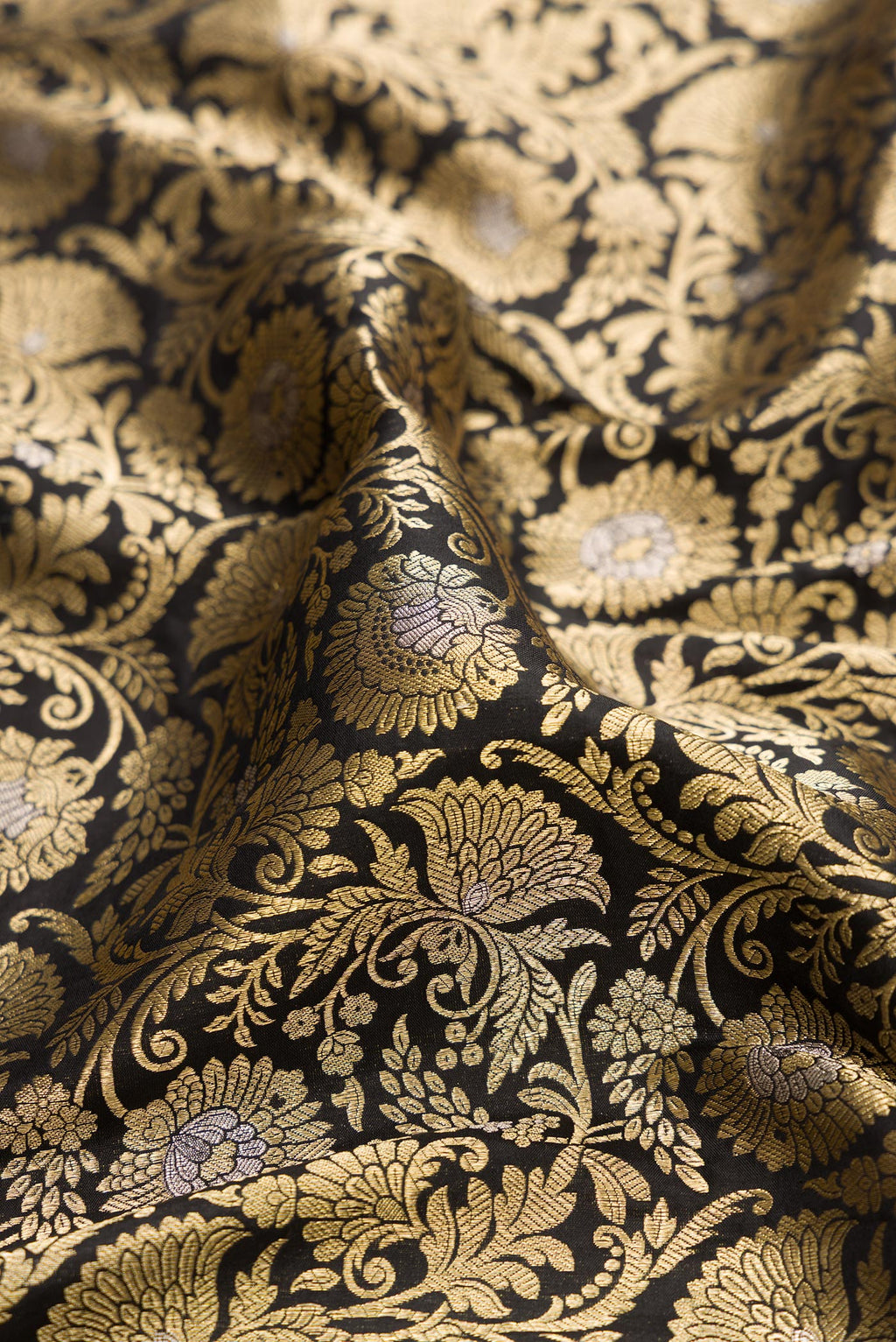 Close up of Black Banarasi Silk Saree with Zari Brocade on the body and Zari Border.  displaying folds