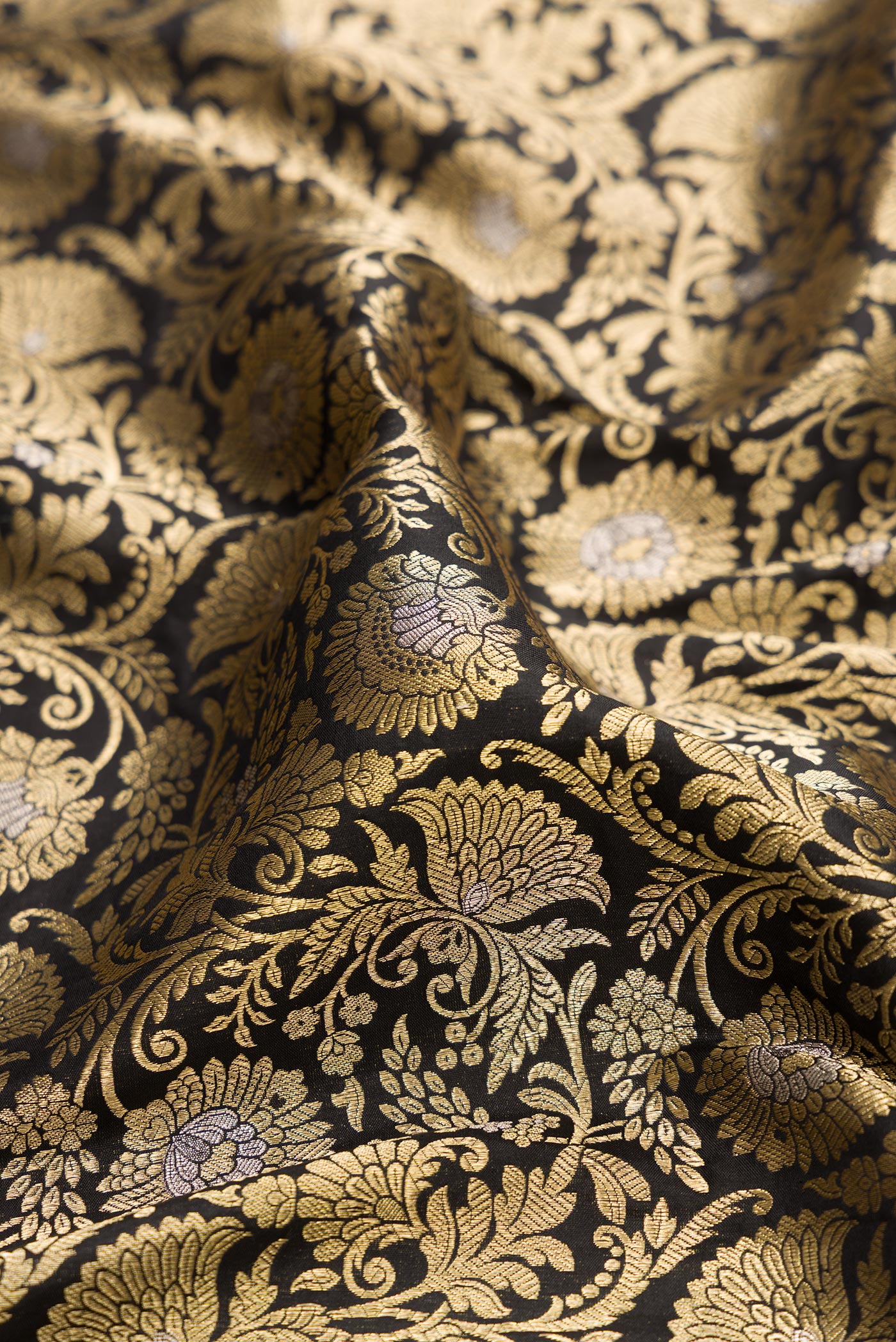 Close up of Black Banarasi Silk Saree with Zari Brocade on the body and Zari Border.  displaying folds