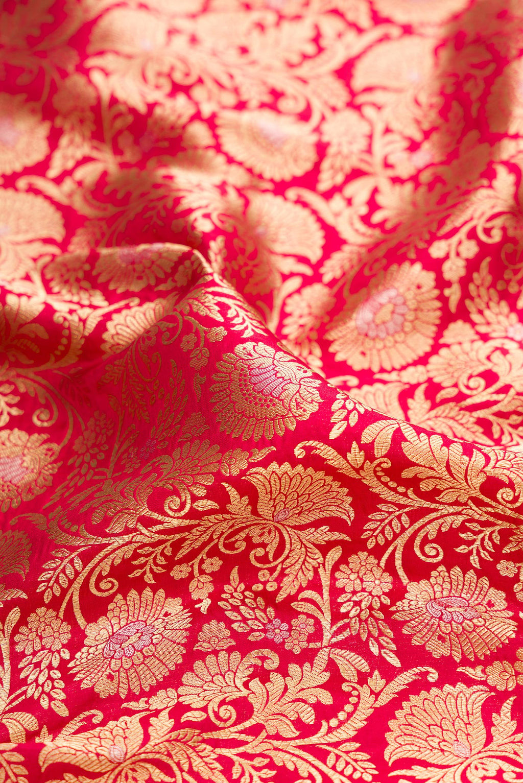 Close up of Dark Pink Dual Tone Banarasi Silk Saree with Zari Brocade on the body and Zari Border.  displaying folds