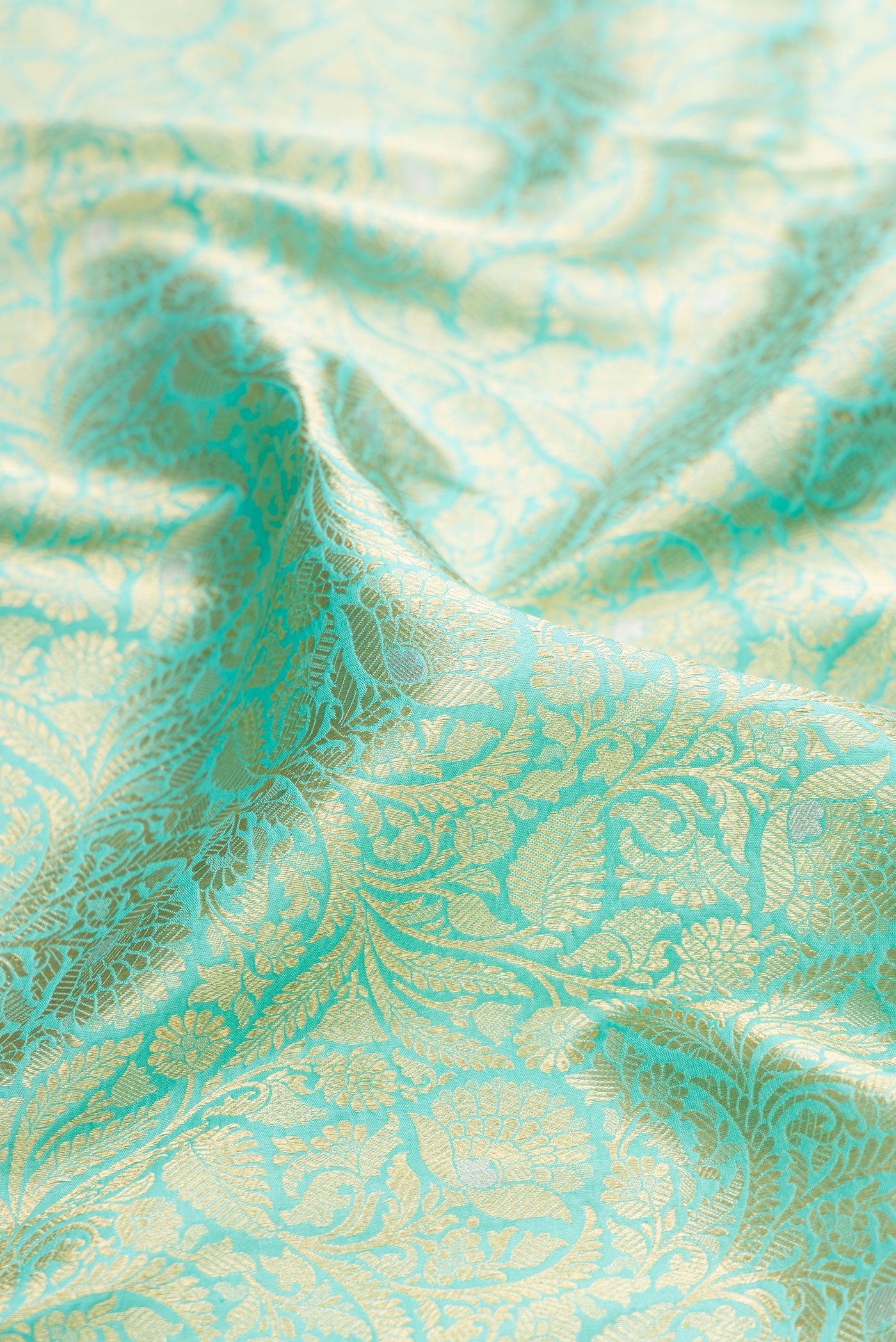 Close up of Sky Blue Banarasi Silk Saree with Zari Brocade on the body and Zari Border.  displaying folds