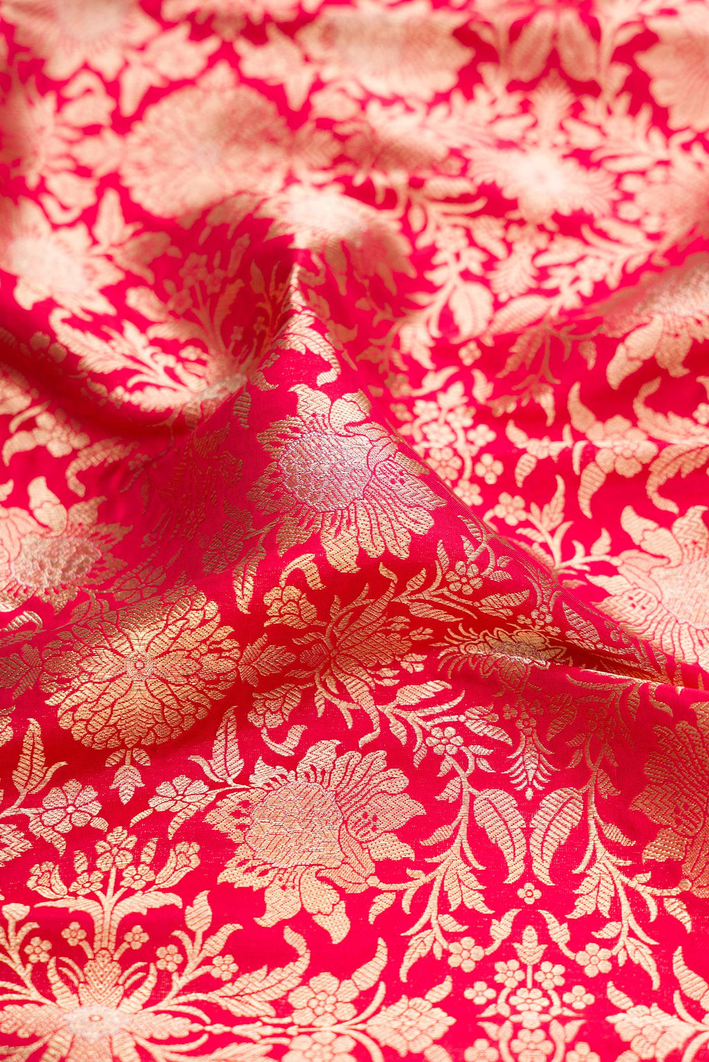 Close up of Dark Pink Banarasi Silk Saree with Zari Brocade on the body and Zari Border.  displaying folds