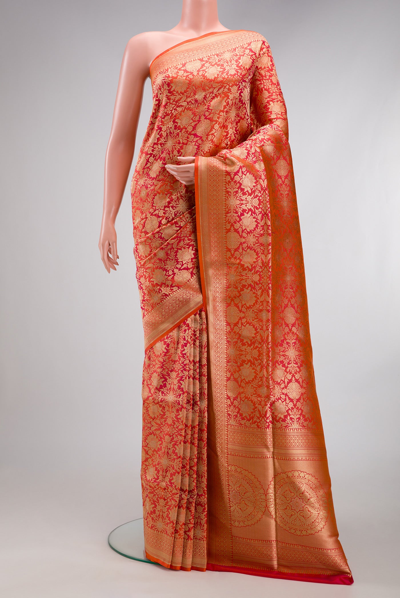 Orange Banarasi Silk Saree with Zari Brocade on the body and Zari Border.  displayed on a mannequin