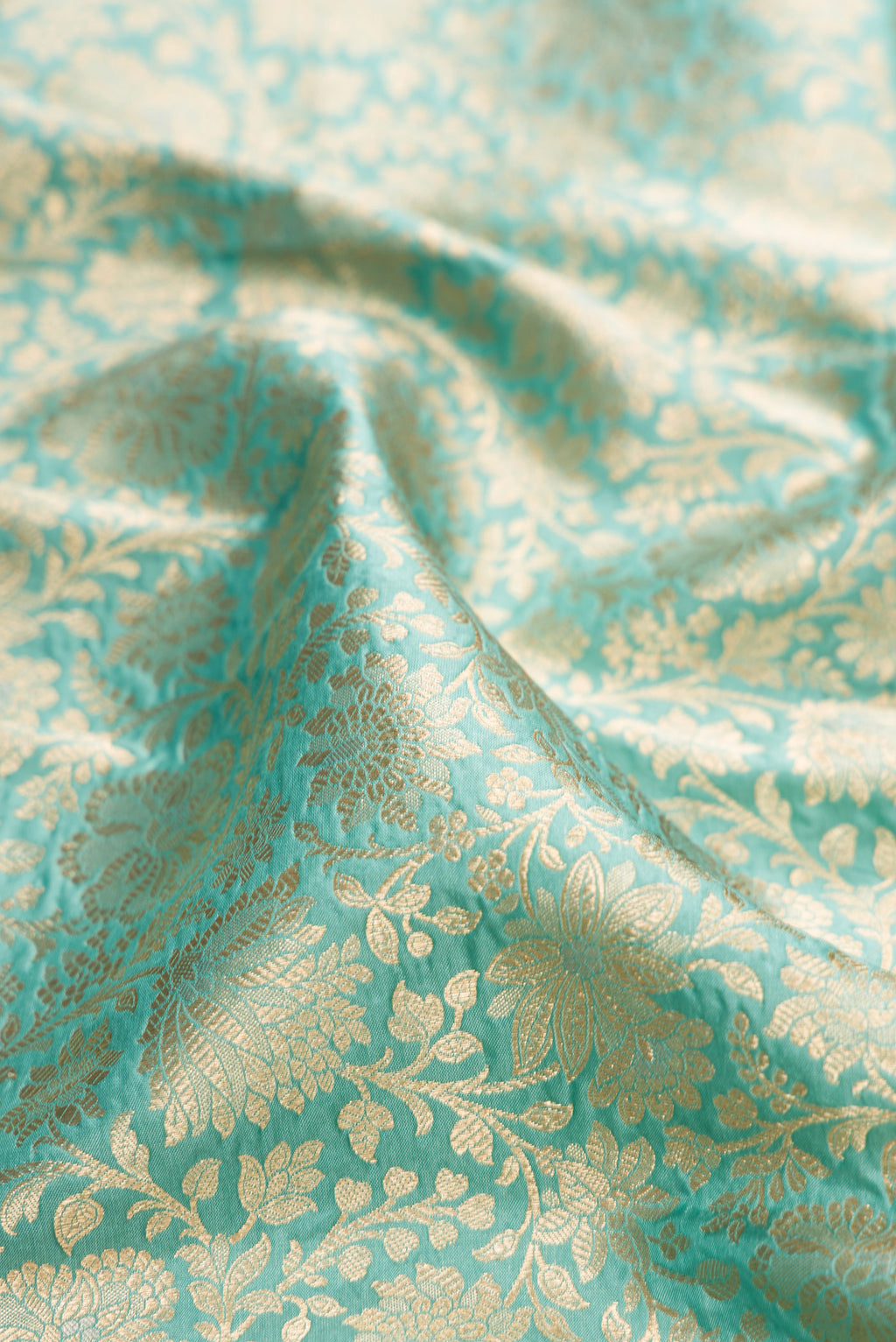 Close up of Light Blue Banarasi Silk Saree with Zari Brocade on the body and Zari Border.  displaying folds