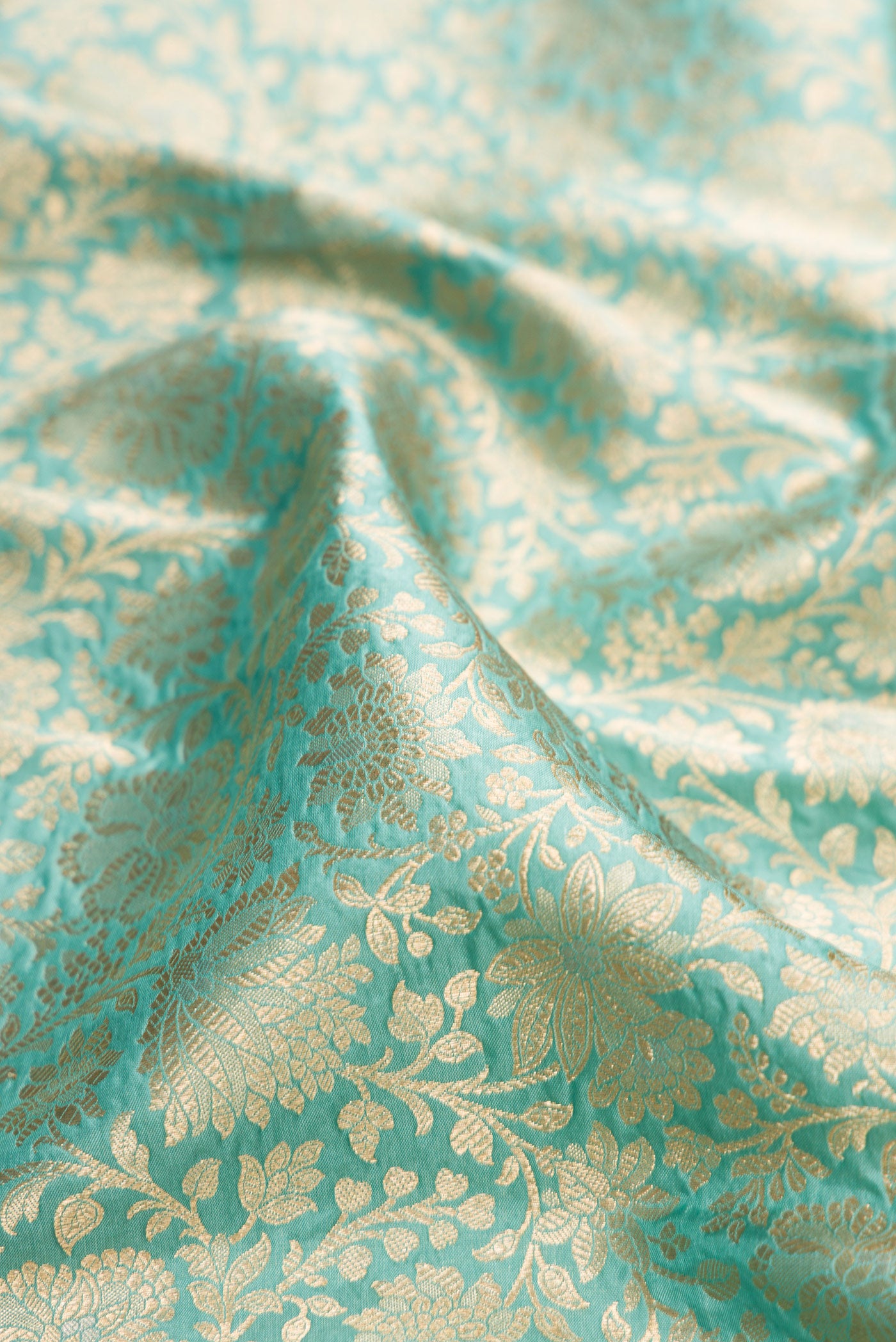 Close up of Light Blue Banarasi Silk Saree with Zari Brocade on the body and Zari Border.  displaying folds