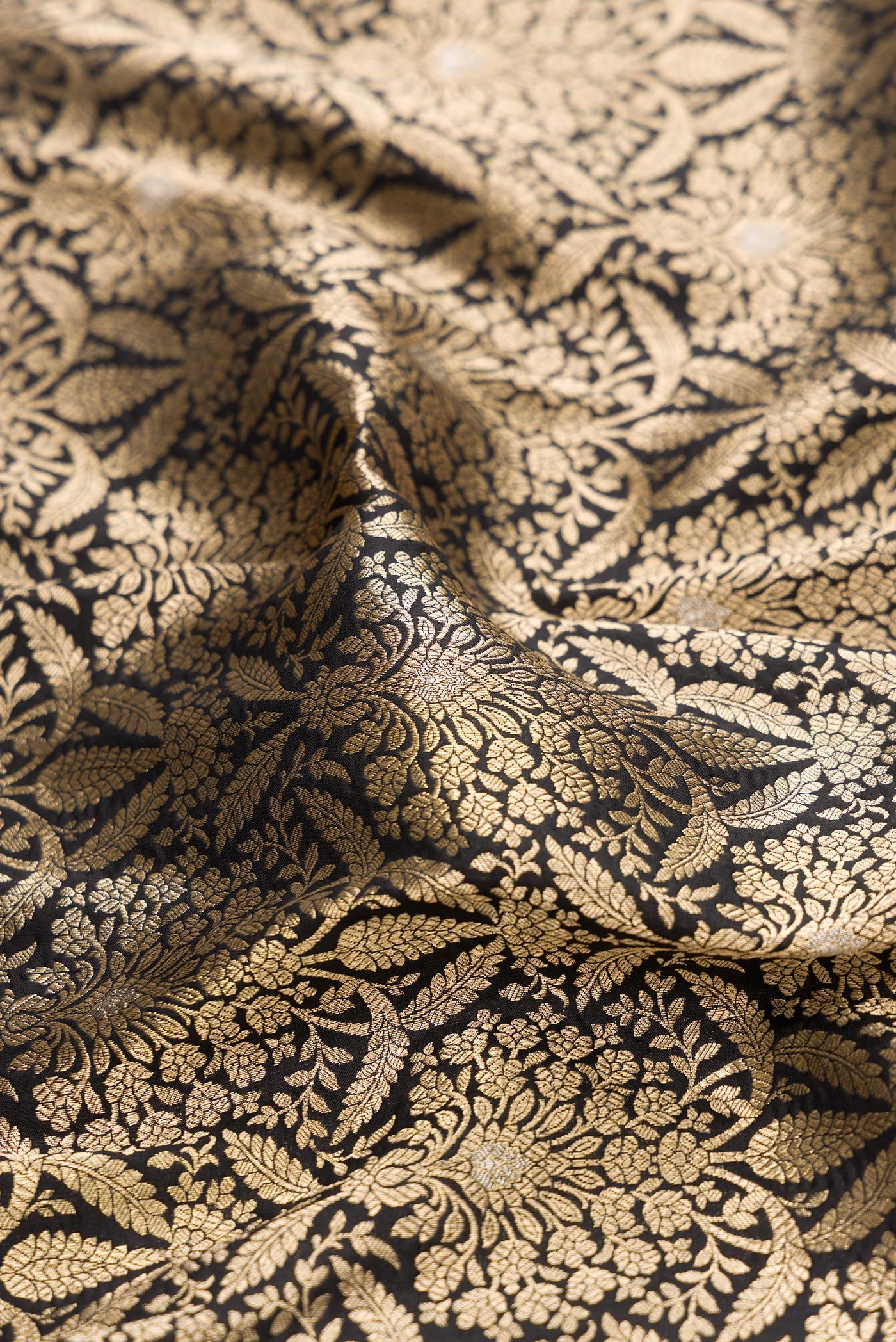 Close up of Black Banarasi Silk Saree with Zari Brocade on the body and Zari Border.  displaying folds