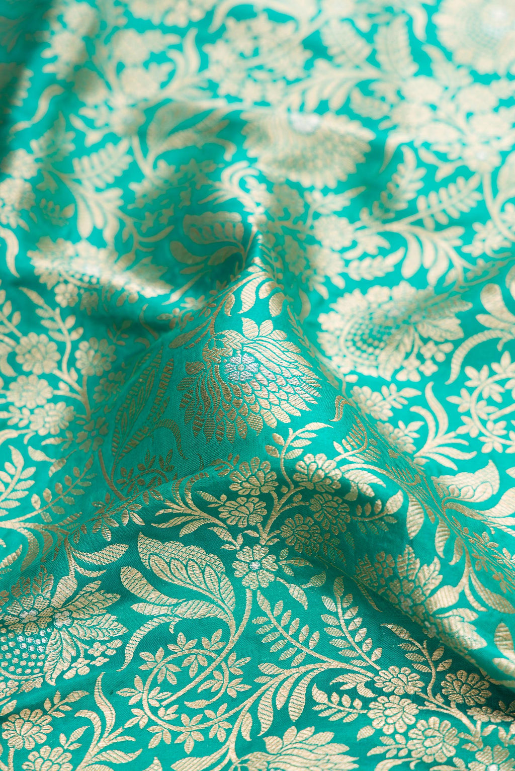 Close up of Sea Green Banarasi Silk Saree with Zari Brocade on the body and Zari Border.  displaying folds