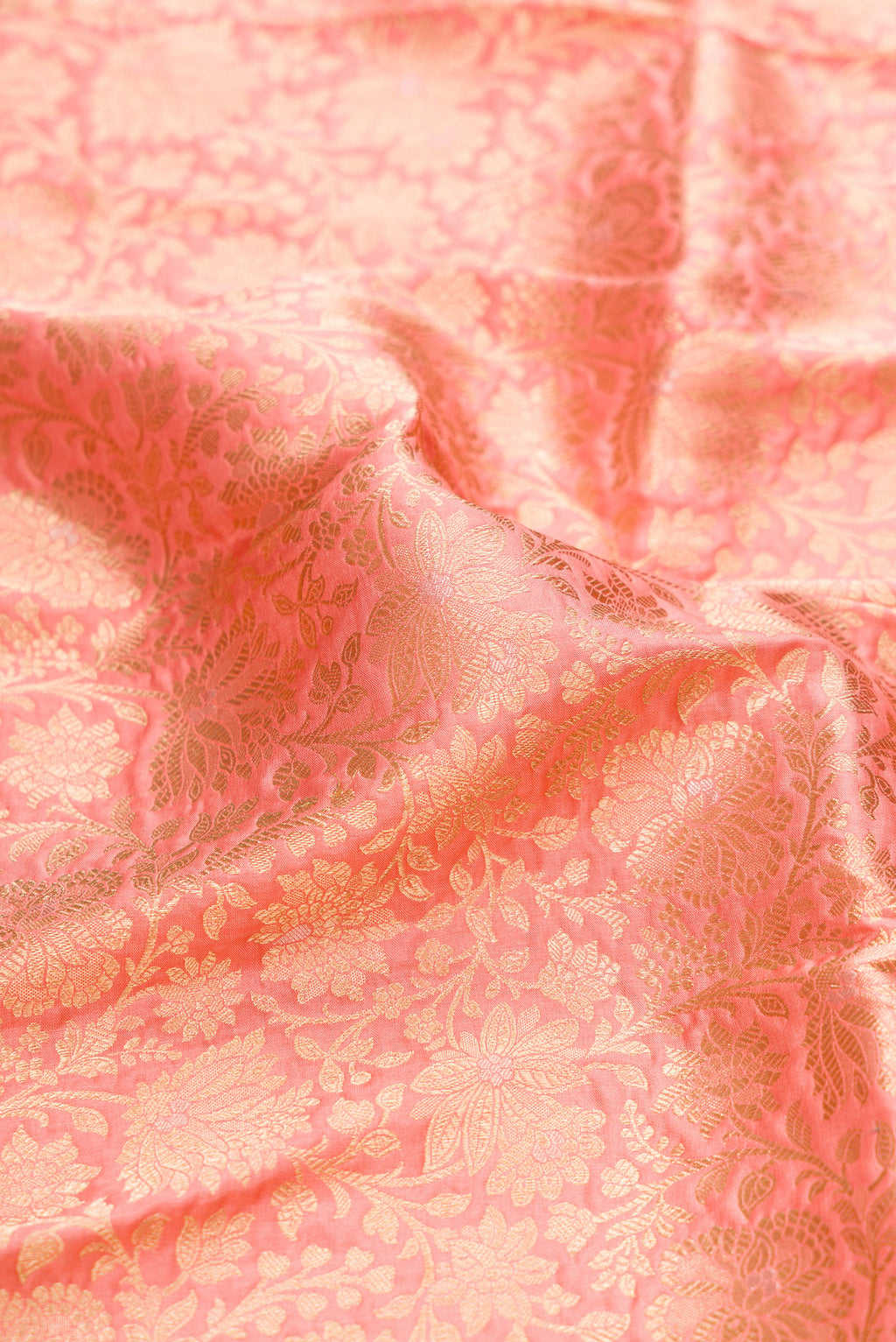 Close up of Golden Peach Banarasi Silk Saree with Zari Brocade on the body and Zari Border.  displaying folds