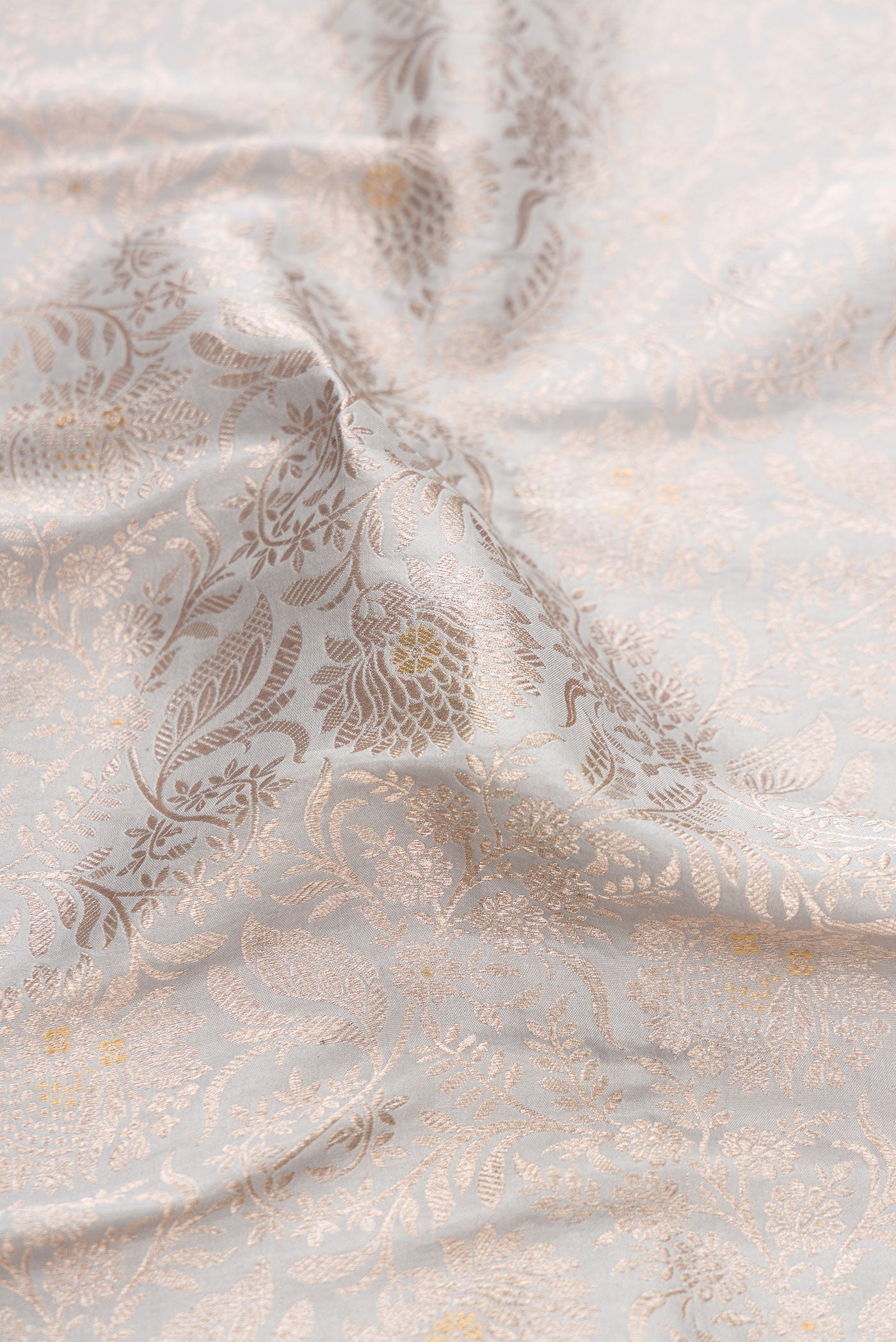 Close up of Grey Banarasi Silk Saree with Zari Brocade on the body and Zari Border.  displaying folds