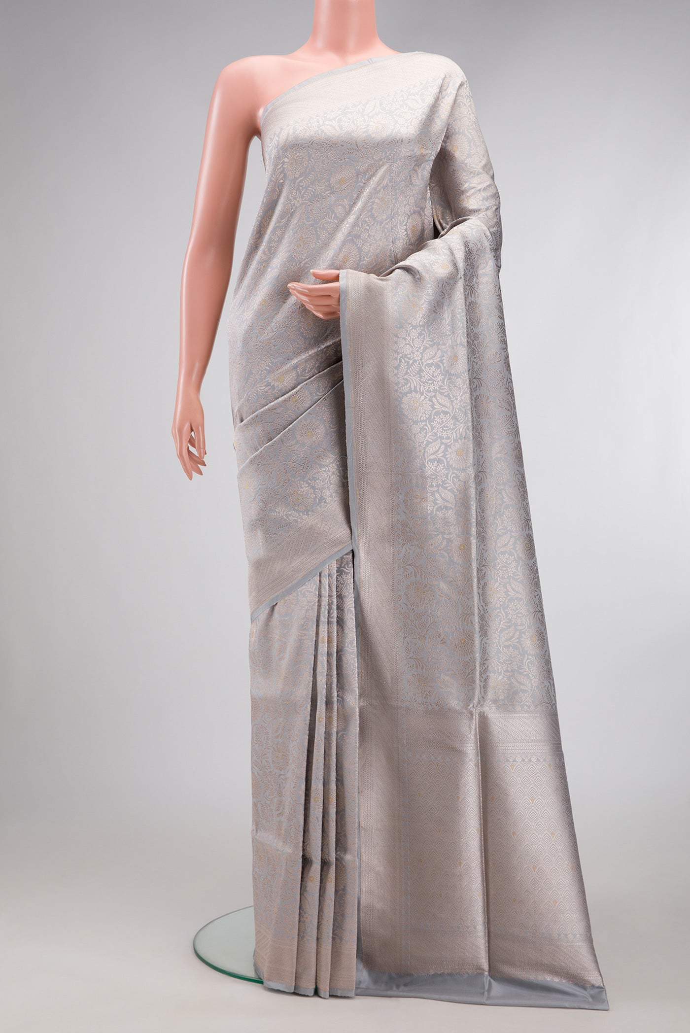 Grey Banarasi Silk Saree with Zari Brocade on the body and Zari Border.  displayed on a mannequin