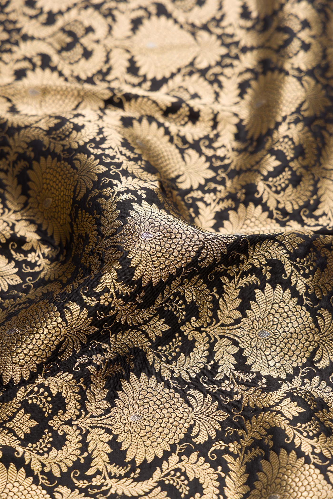 Close up of Black Banarasi Silk Saree with Zari Brocade on the body and Zari Border.  displaying folds