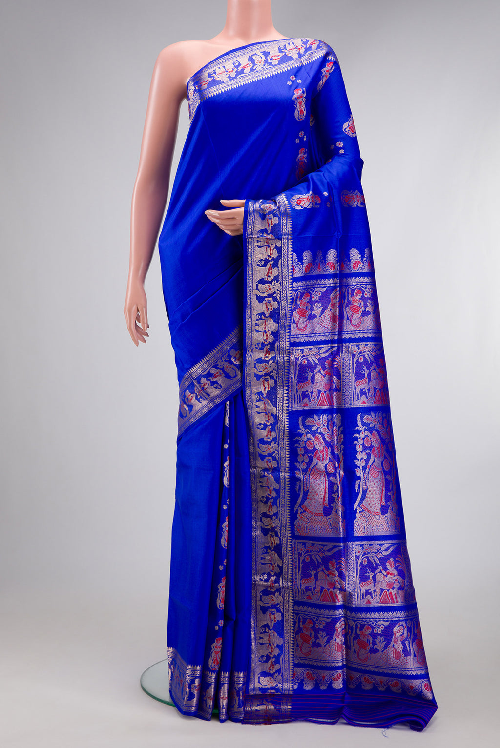 Royal Blue Baluchari Silk Saree with Zari And Thread Butta on the body and Zari And Thread Border.  displayed on a mannequin
