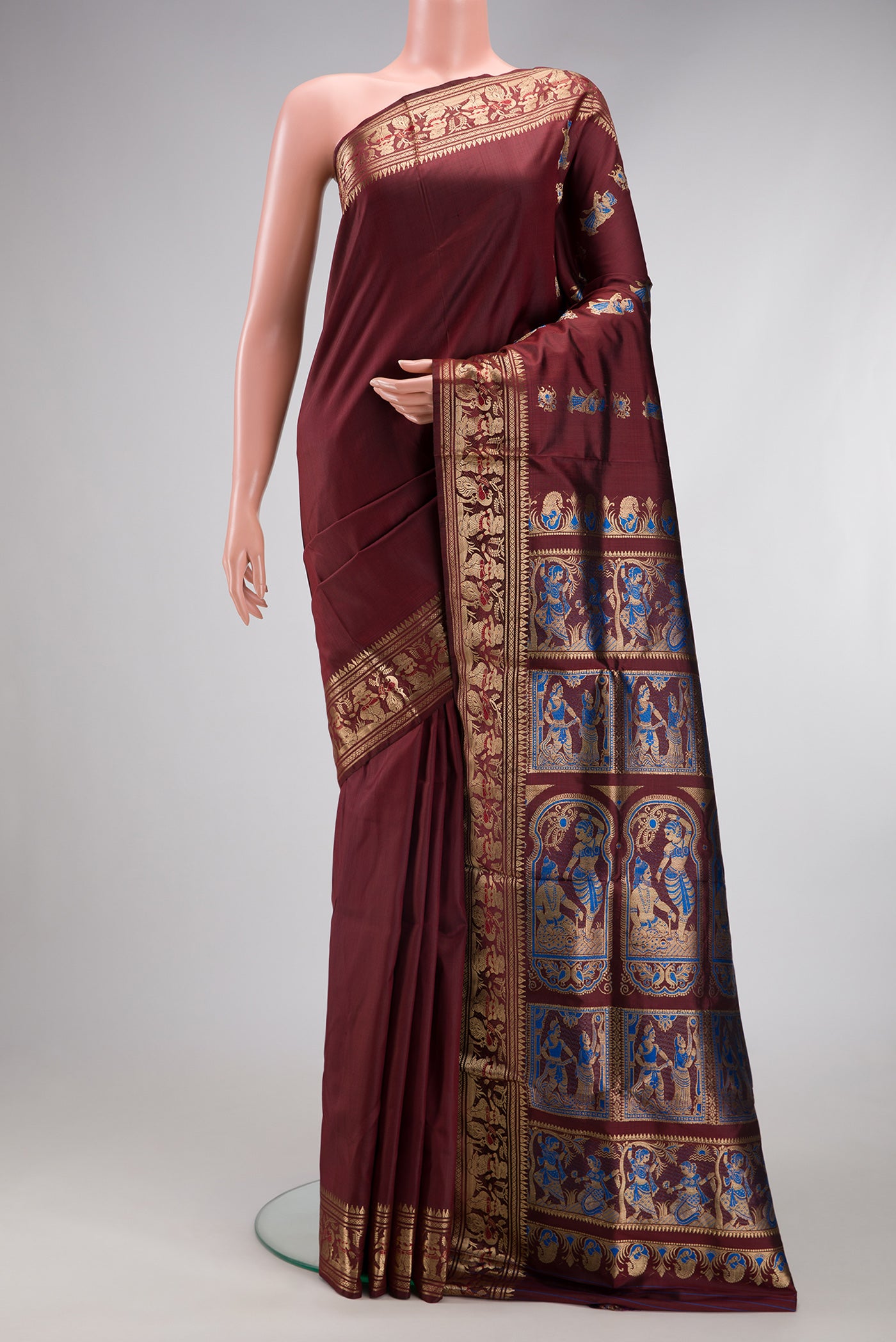 Coffee Brown Baluchari Silk Saree with Zari And Thread Butta on the body and Zari Border.  displayed on a mannequin