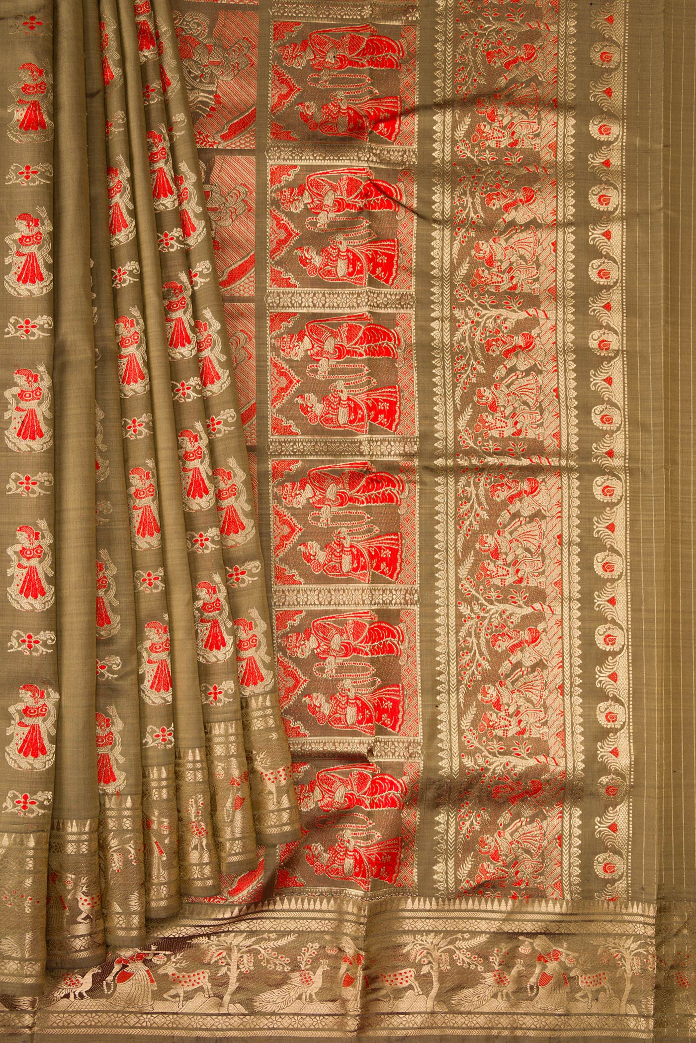Pleats and pallu of Dark Beige Baluchari Silk Saree with Zari And Thread Butta on the body and Zari Border. 