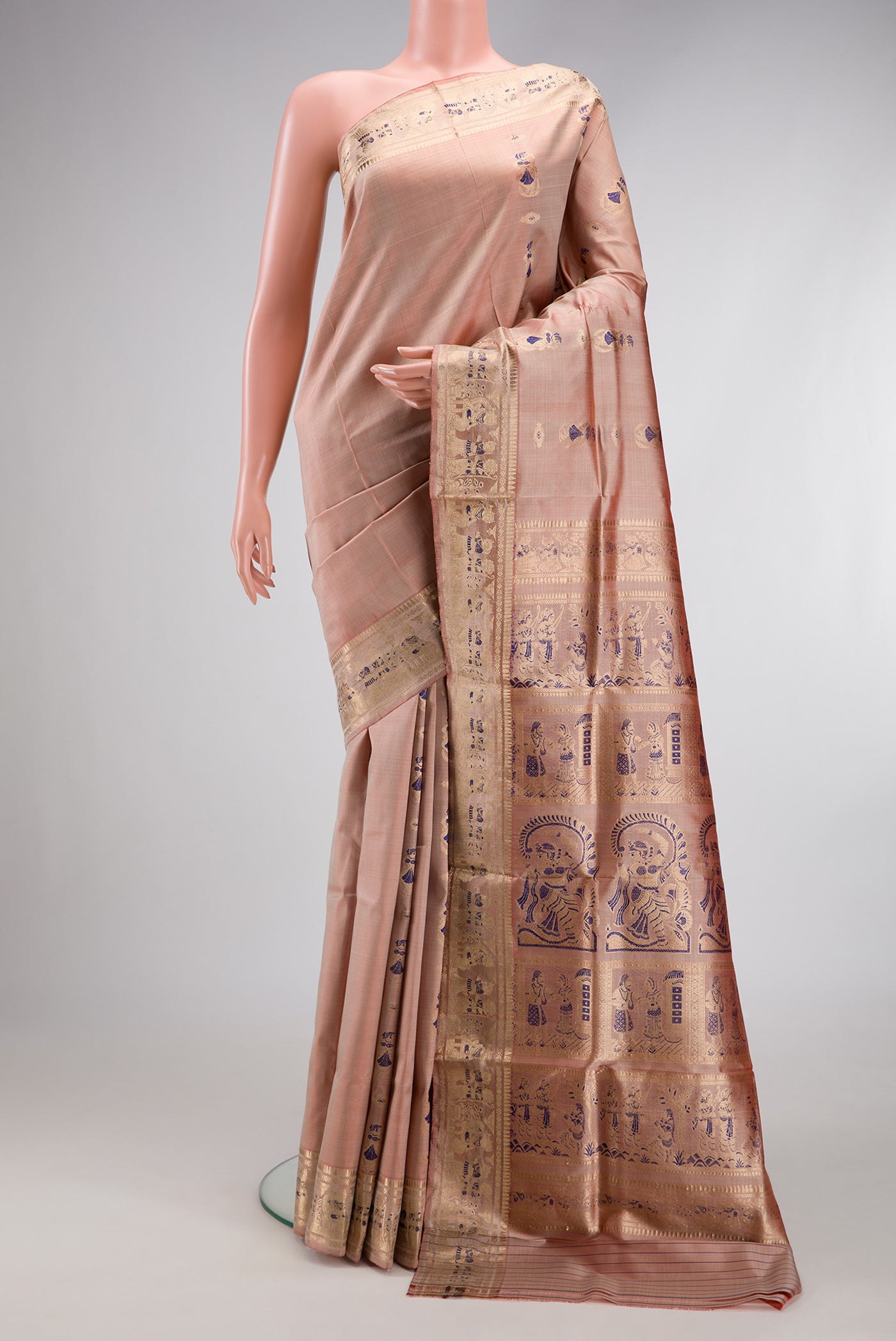 Rose Gold Baluchari Silk Saree with Zari And Thread Butta on the body and Zari And Thread Border.  displayed on a mannequin