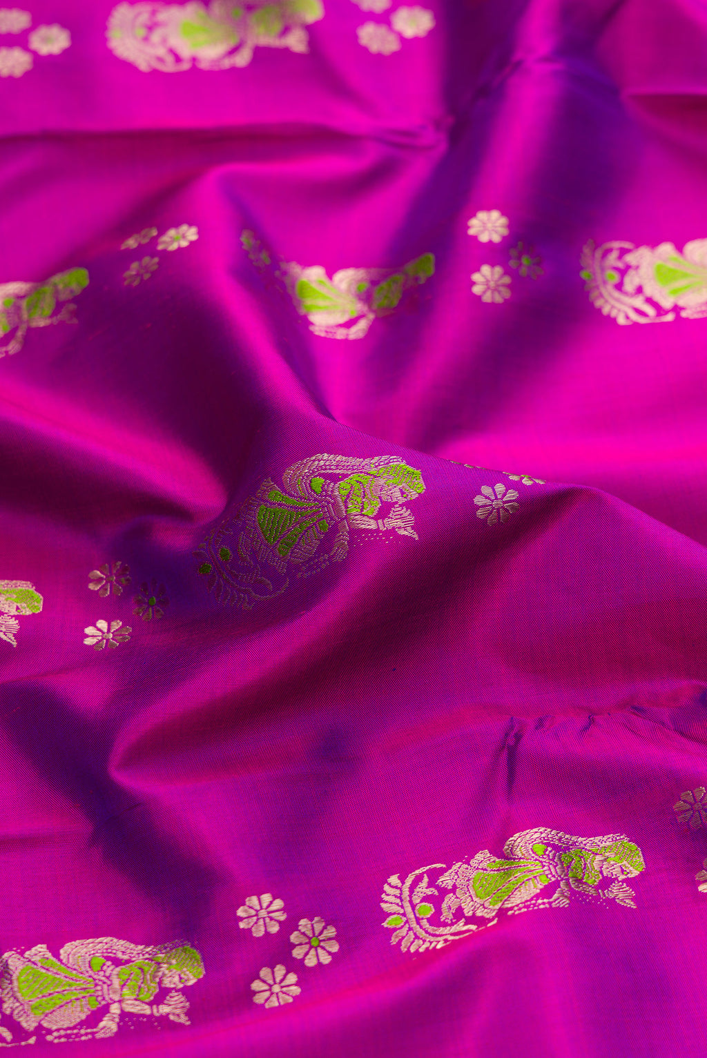 Close up of Purple Baluchari Silk Saree with Zari And Thread Butta on the body and Zari Border.  displaying folds