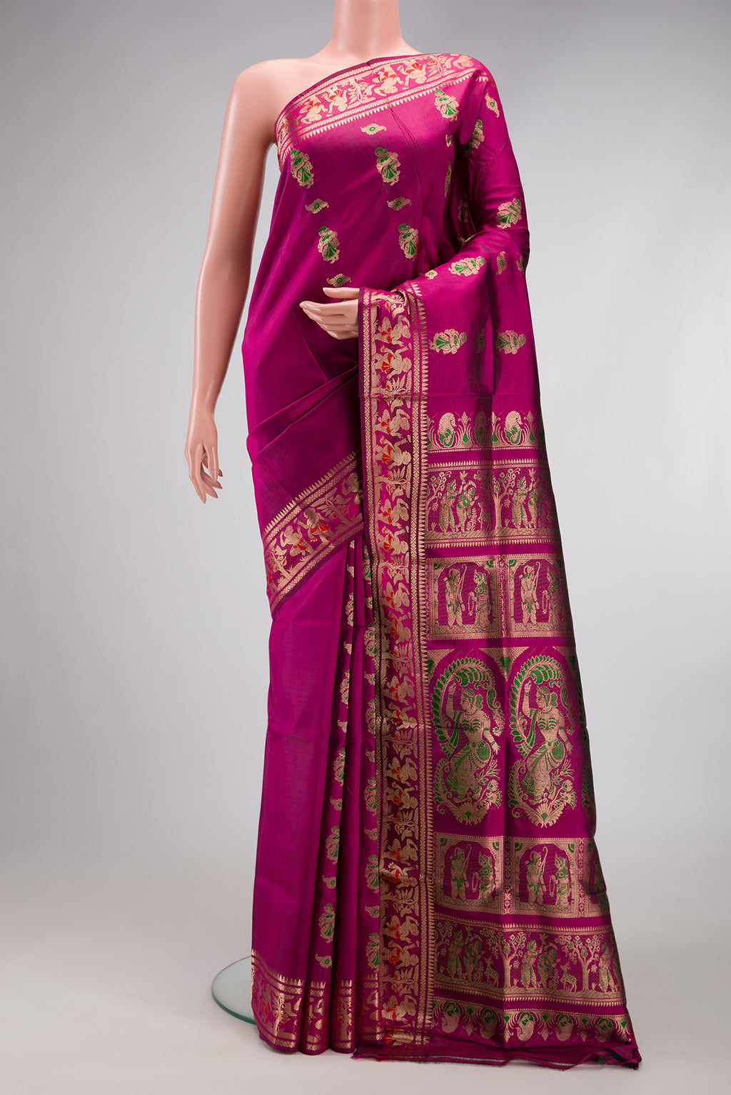 Magenta Baluchari Silk Saree with Zari And Thread Butta on the body and Zari Border.  displayed on a mannequin
