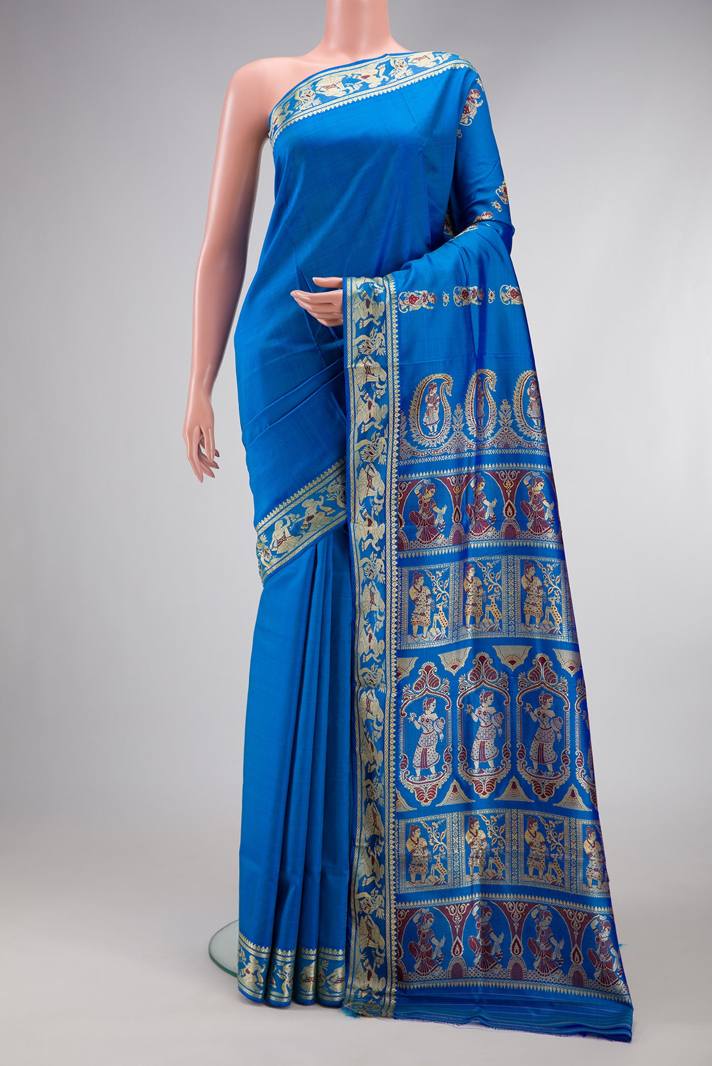 Royal Blue Baluchari Silk Saree with Thread Butta on the body and Thread Border.  displayed on a mannequin
