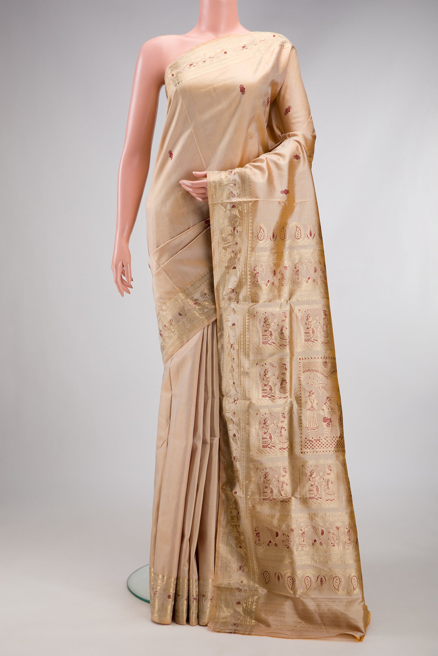 Beige Baluchari Silk Saree with Zari And Thread Butta on the body and Zari And Thread Border.  displayed on a mannequin