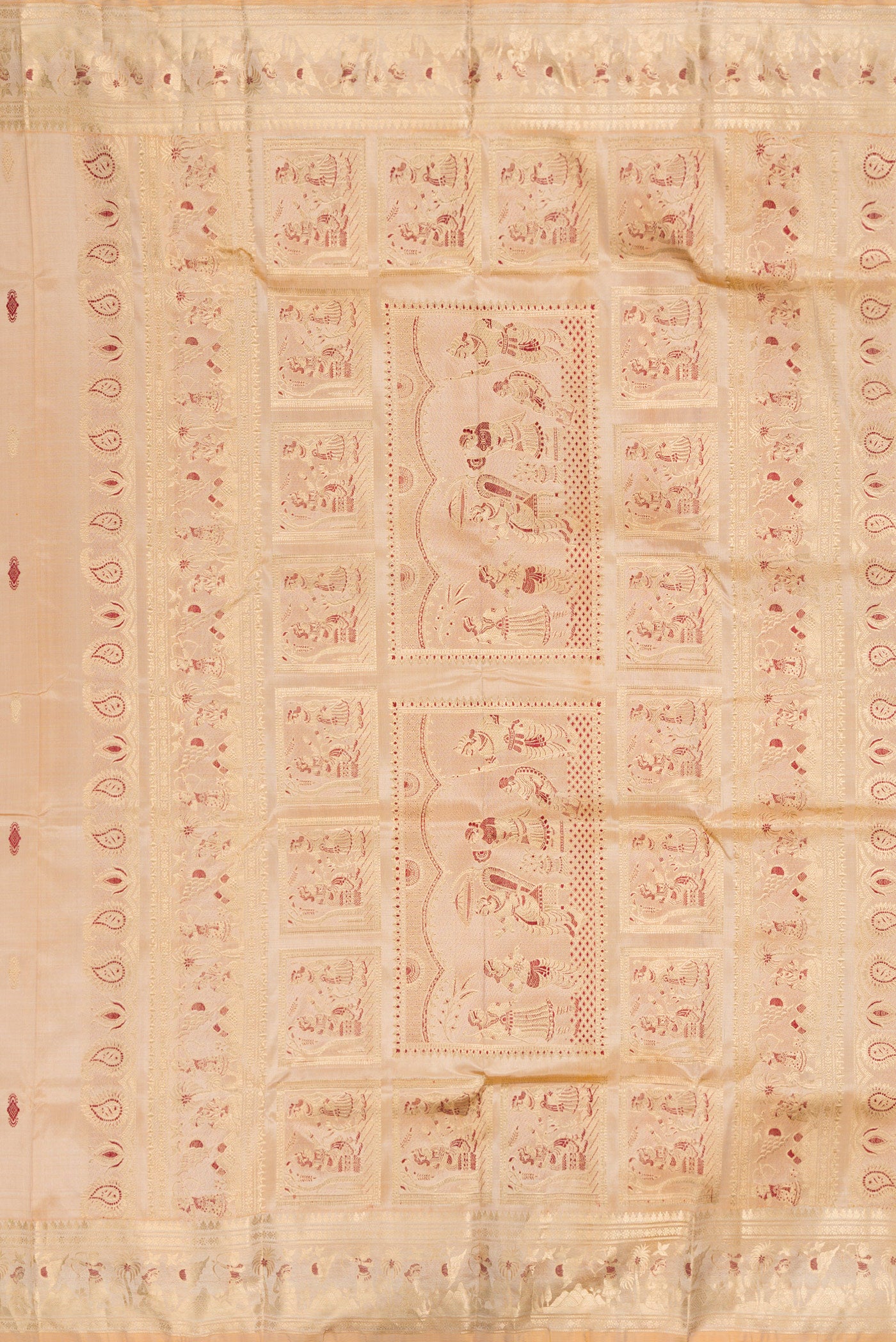 Close up image of the pallu of Beige Baluchari Silk Saree with Zari And Thread Butta on the body and Zari And Thread Border. 