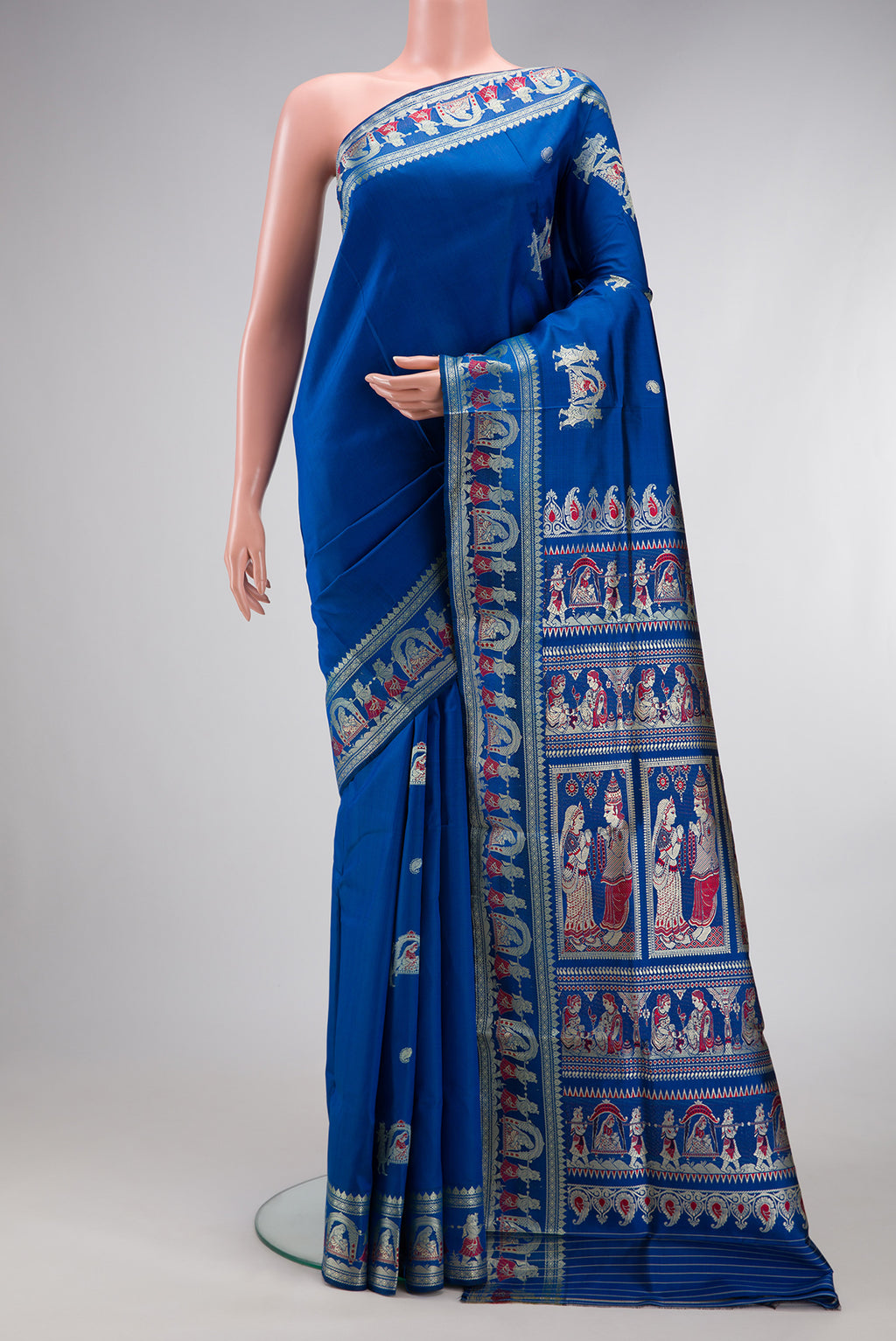 Royal Blue Baluchari Silk Saree with Thread Butta on the body and Thread Border.  displayed on a mannequin