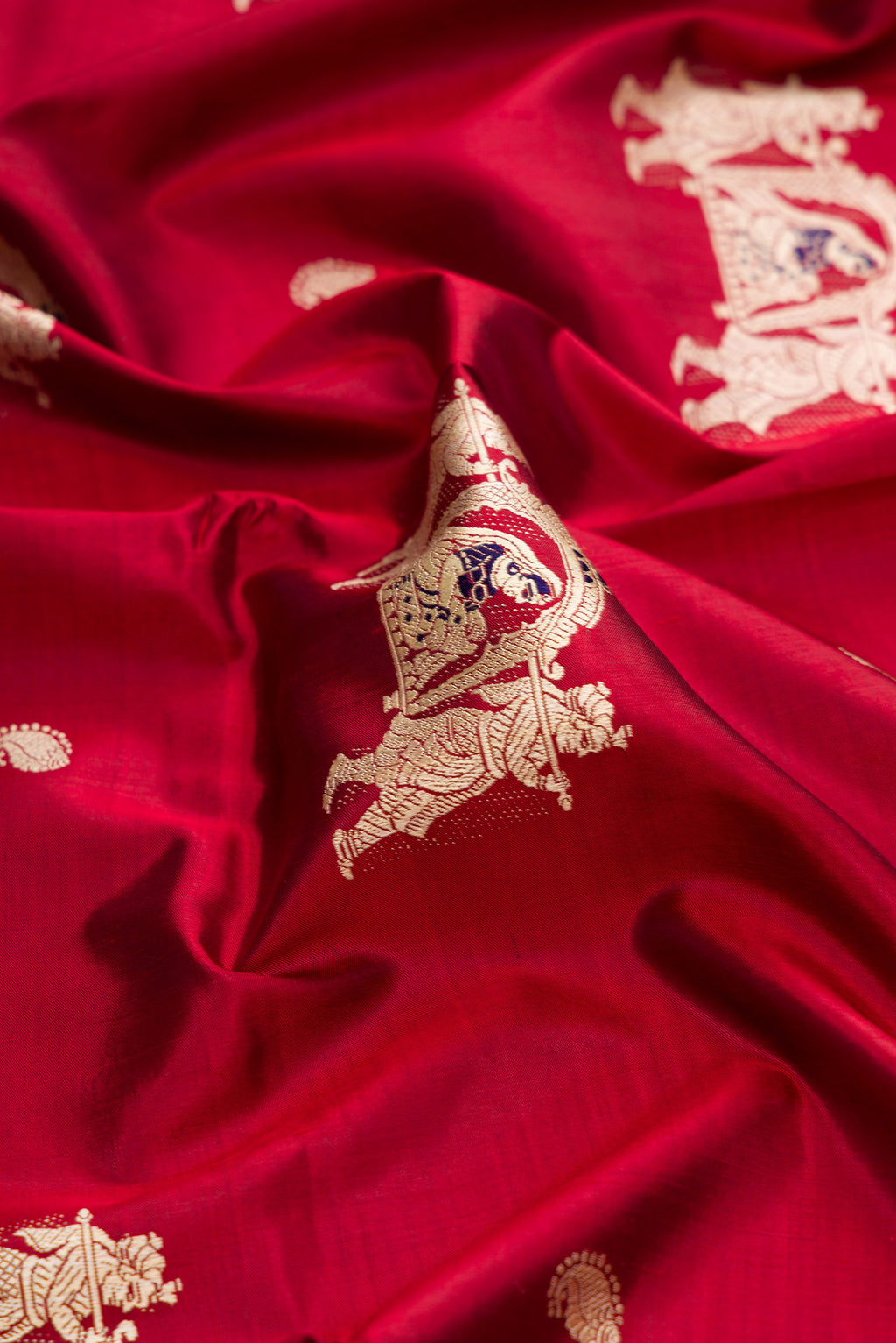 Close up of Maroon Baluchari Silk Saree with Thread Butta on the body and Thread Border.  displaying folds
