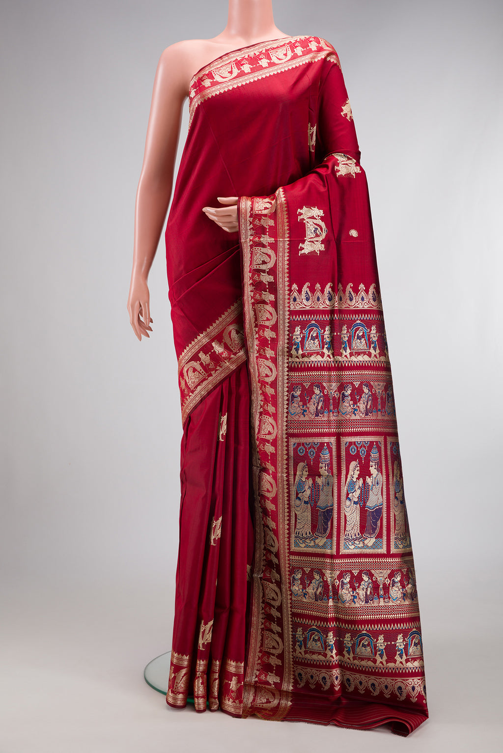 Maroon Baluchari Silk Saree with Thread Butta on the body and Thread Border.  displayed on a mannequin