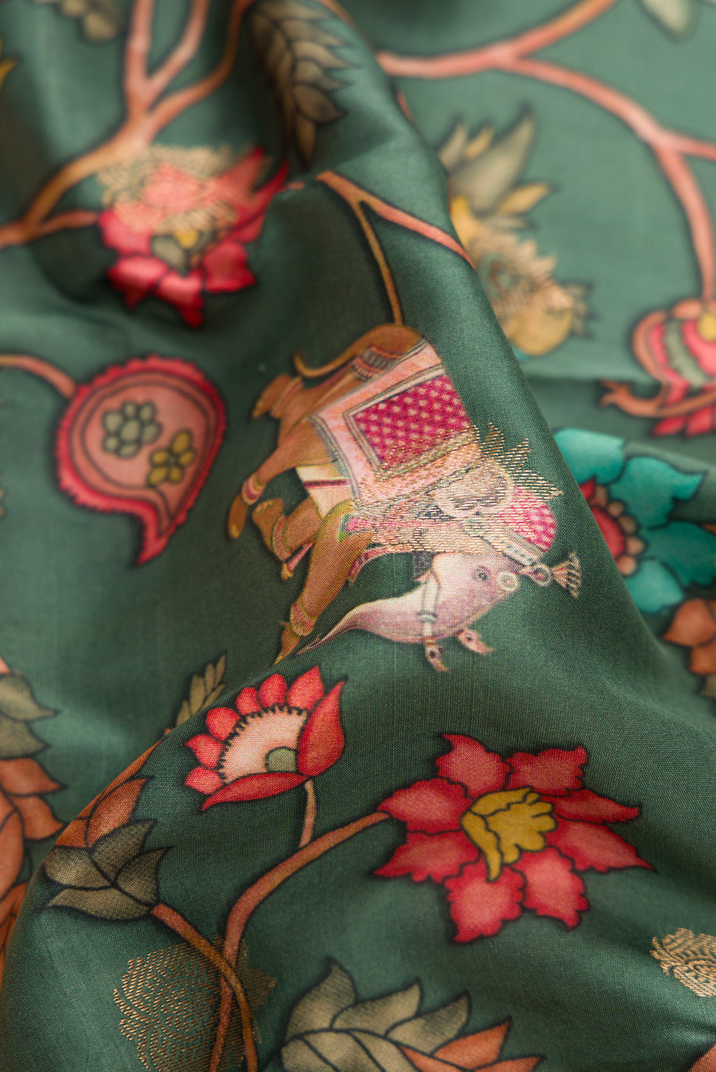 Close up of Green Kanjivaram Silk Saree with Floral Print on the body and Zari Border.  displaying folds