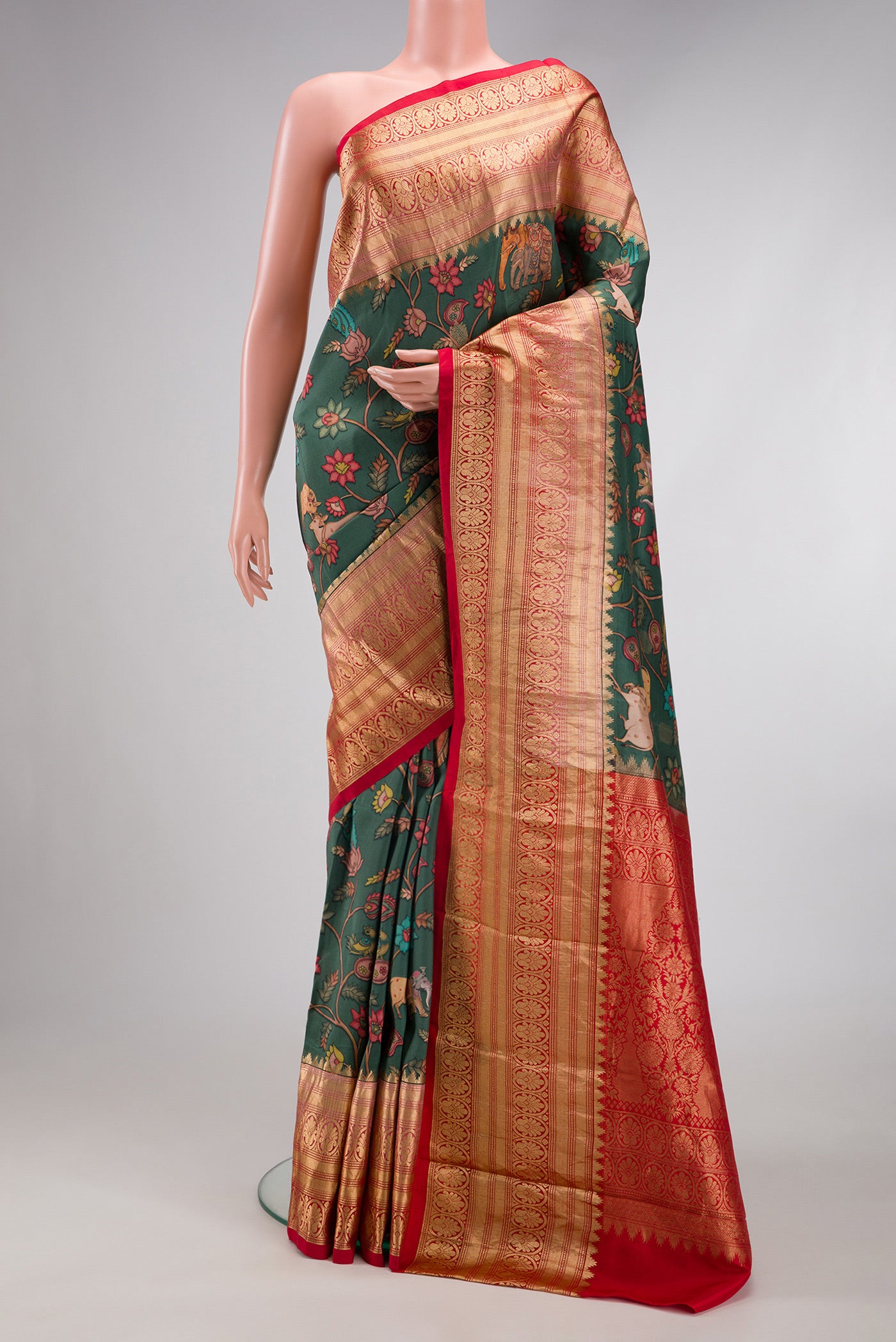 Green Kanjivaram Silk Saree with Floral Print on the body and Zari Border.  displayed on a mannequin