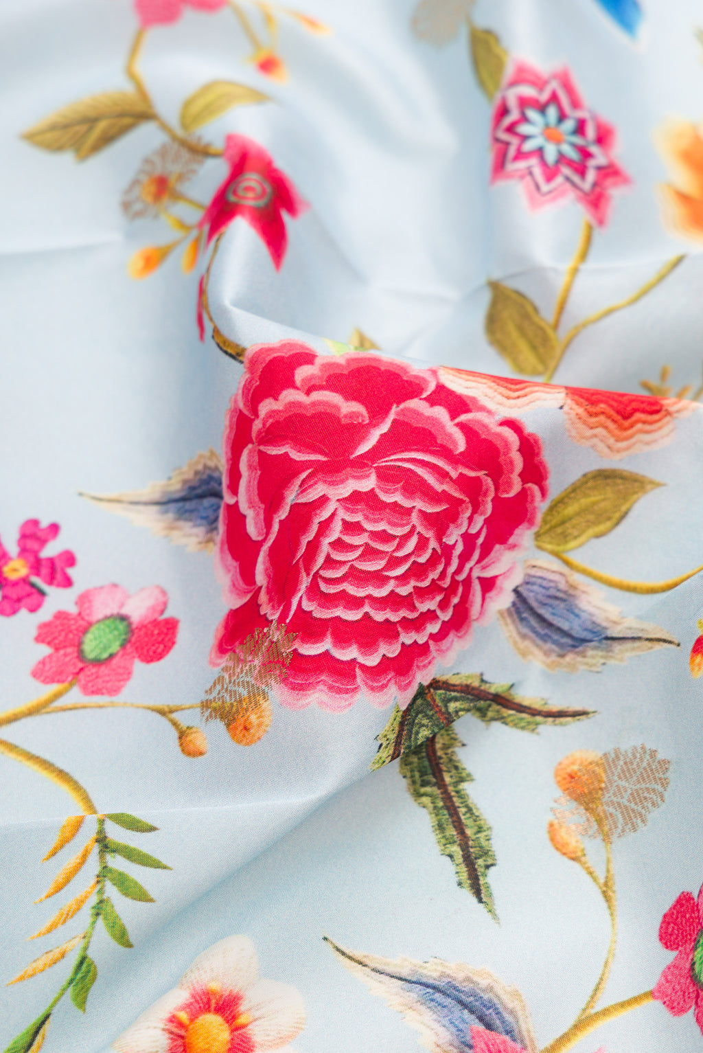 Close up of Light Blue Kanjivaram Silk Saree with Floral Print on the body and Zari Border.  displaying folds