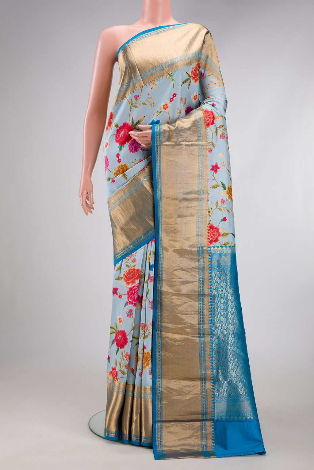 Light Blue Kanjivaram Silk Saree with Floral Print on the body and Zari Border.  displayed on a mannequin