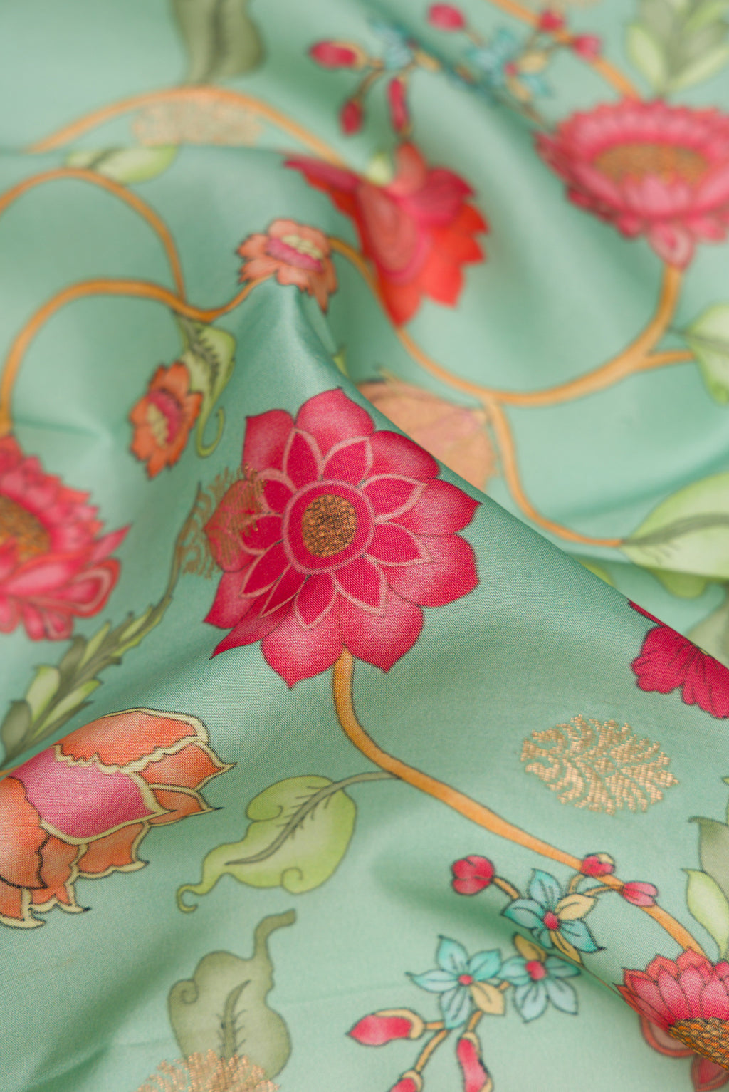 Close up of Sea Green Kanjivaram Silk Saree with Floral Print on the body and Zari Border.  displaying folds