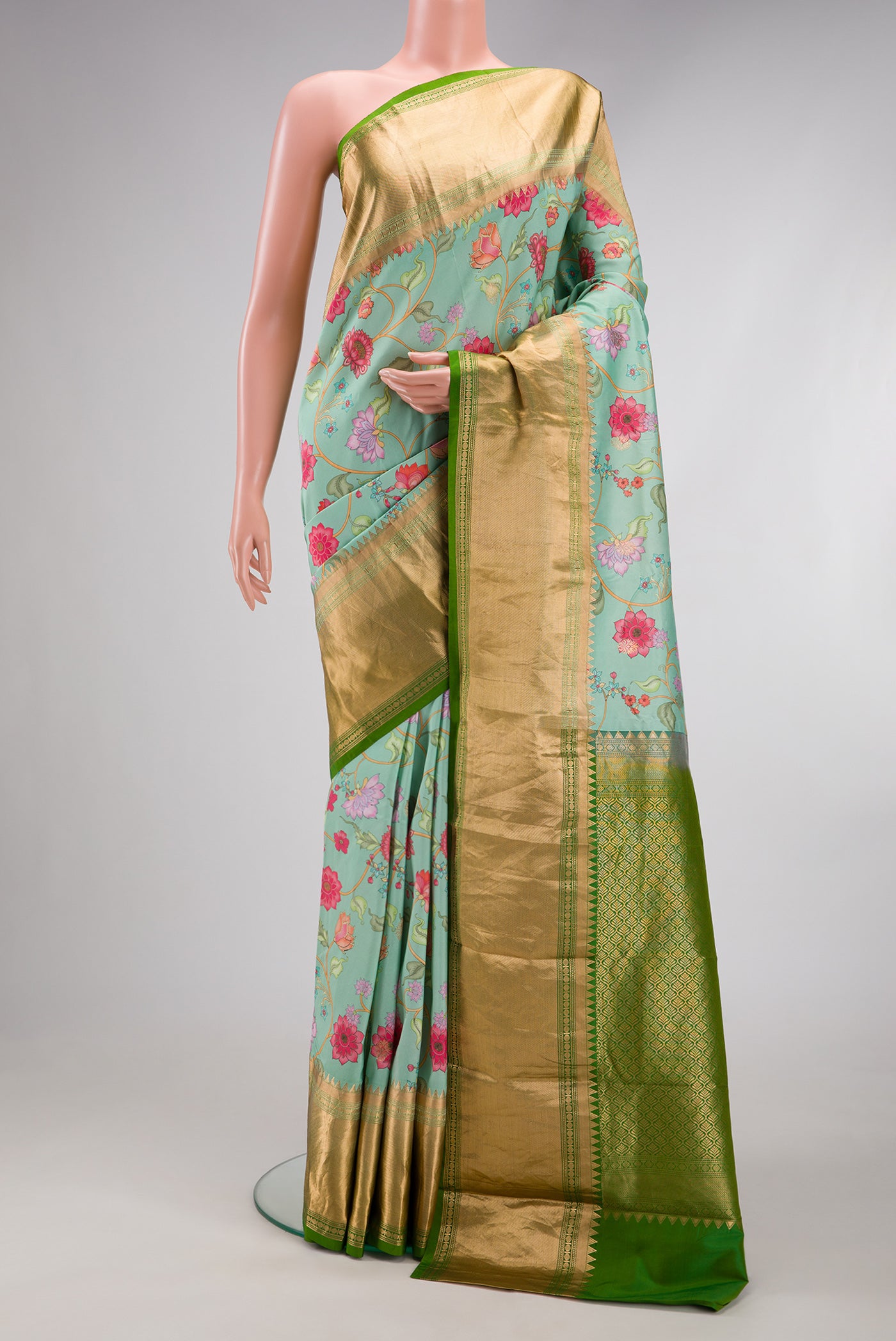 Sea Green Kanjivaram Silk Saree with Floral Print on the body and Zari Border.  displayed on a mannequin