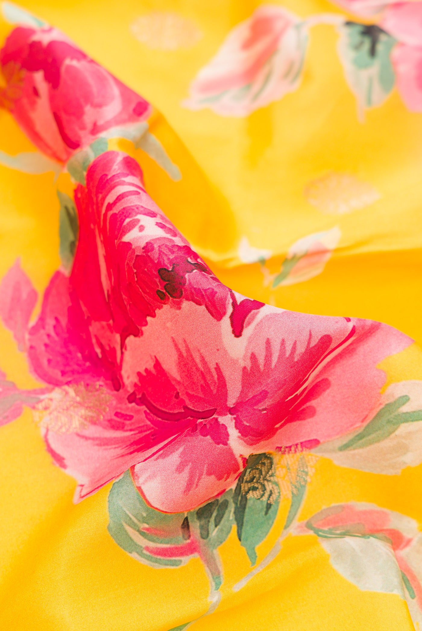 Close up of Yellow Dual Tone Kanjivaram Silk Saree with Floral Print on the body and Zari Border.  displaying folds
