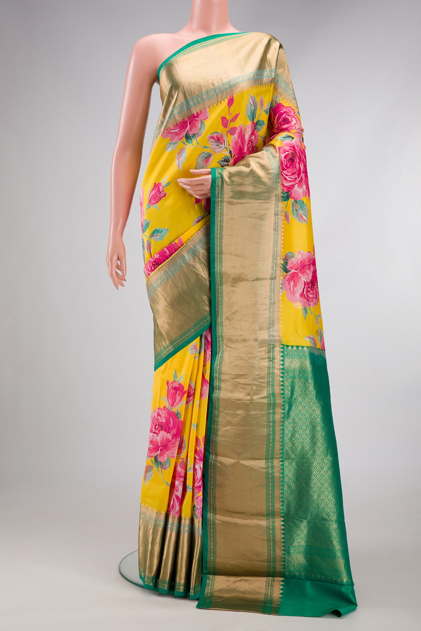 Yellow Dual Tone Kanjivaram Silk Saree with Floral Print on the body and Zari Border.  displayed on a mannequin
