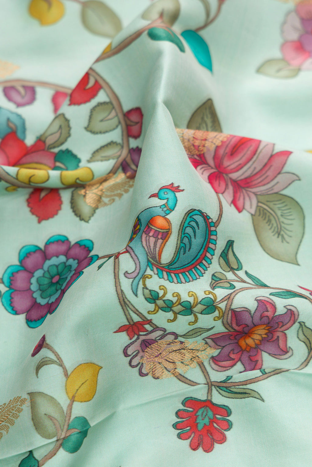 Close up of Light Blue Kanjivaram Silk Saree with Floral Print on the body and Zari Border.  displaying folds