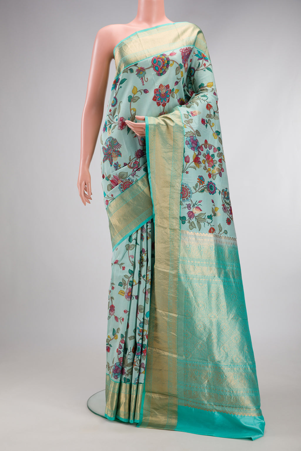 Light Blue Kanjivaram Silk Saree with Floral Print on the body and Zari Border.  displayed on a mannequin