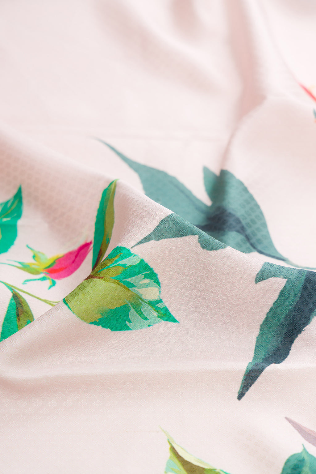 Close up of Pure Silk Cream Kanchipuram Saree with Floral Print on the body and Zari Border.  displaying folds