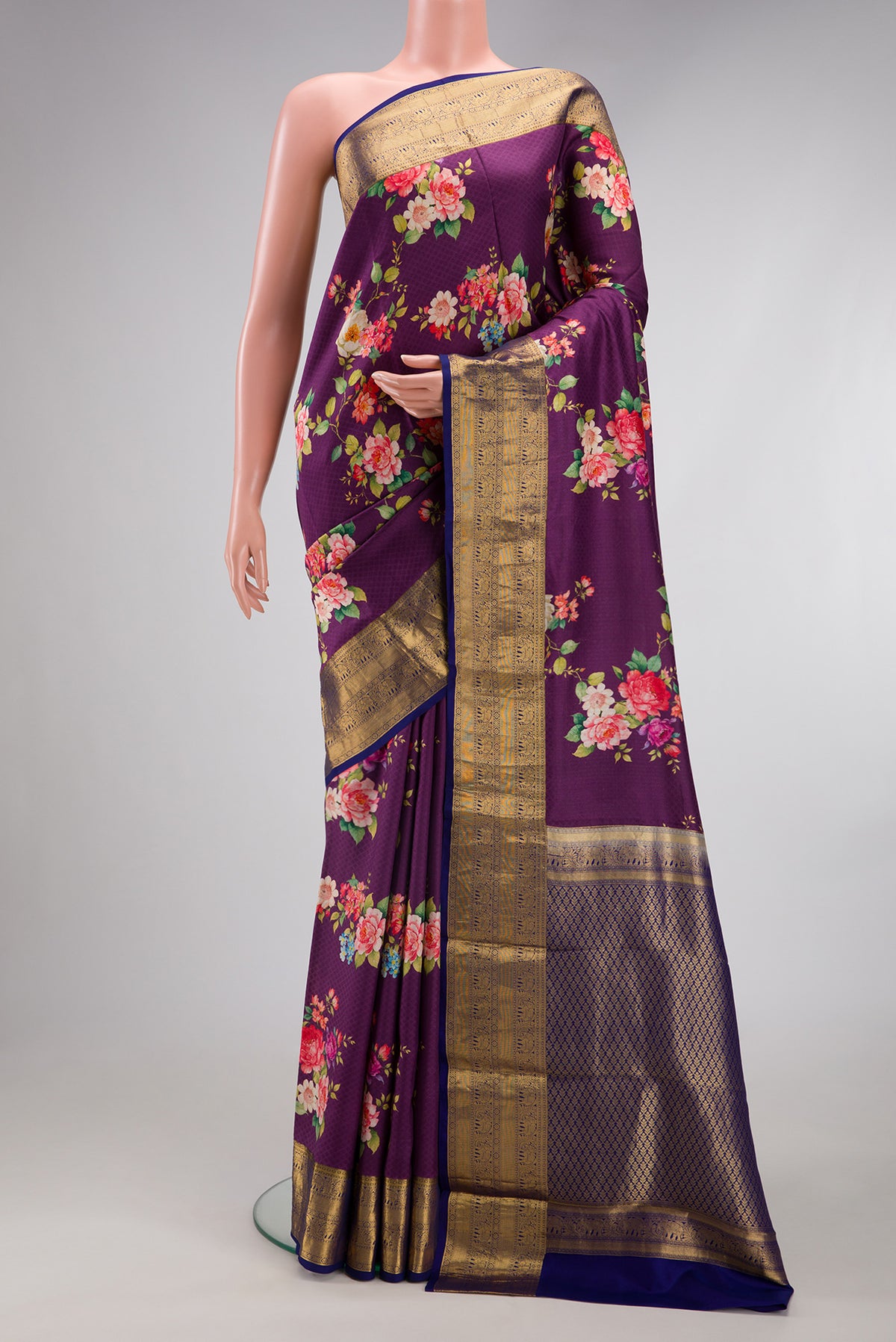 Purple Kanchipuram Silk Saree with Floral Print on the body and Zari Border.  displayed on a mannequin