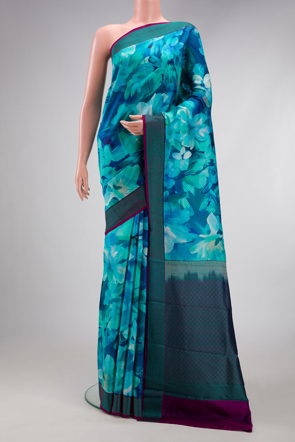 Sky Blue Kanchipuram Silk Saree with Floral Print on the body and Thread Border.  displayed on a mannequin