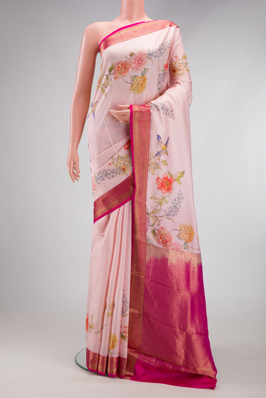 Rose pink Kanchipuram Silk Saree with Floral Print on the body and Zari Border.  displayed on a mannequin