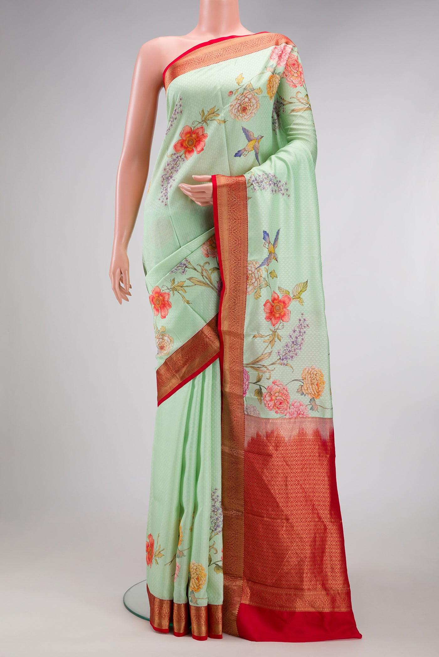 Light Green Dual Tone Kanchipuram Silk Saree with Floral Print on the body and Zari Border.  displayed on a mannequin